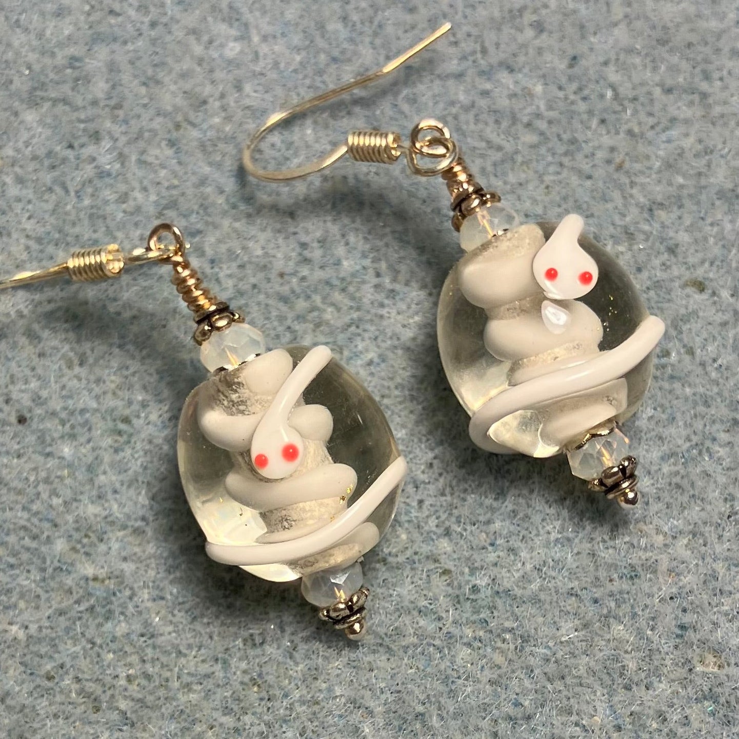 Clear and white lamp work snake bead earrings adorned with white Chinese crystal beads.