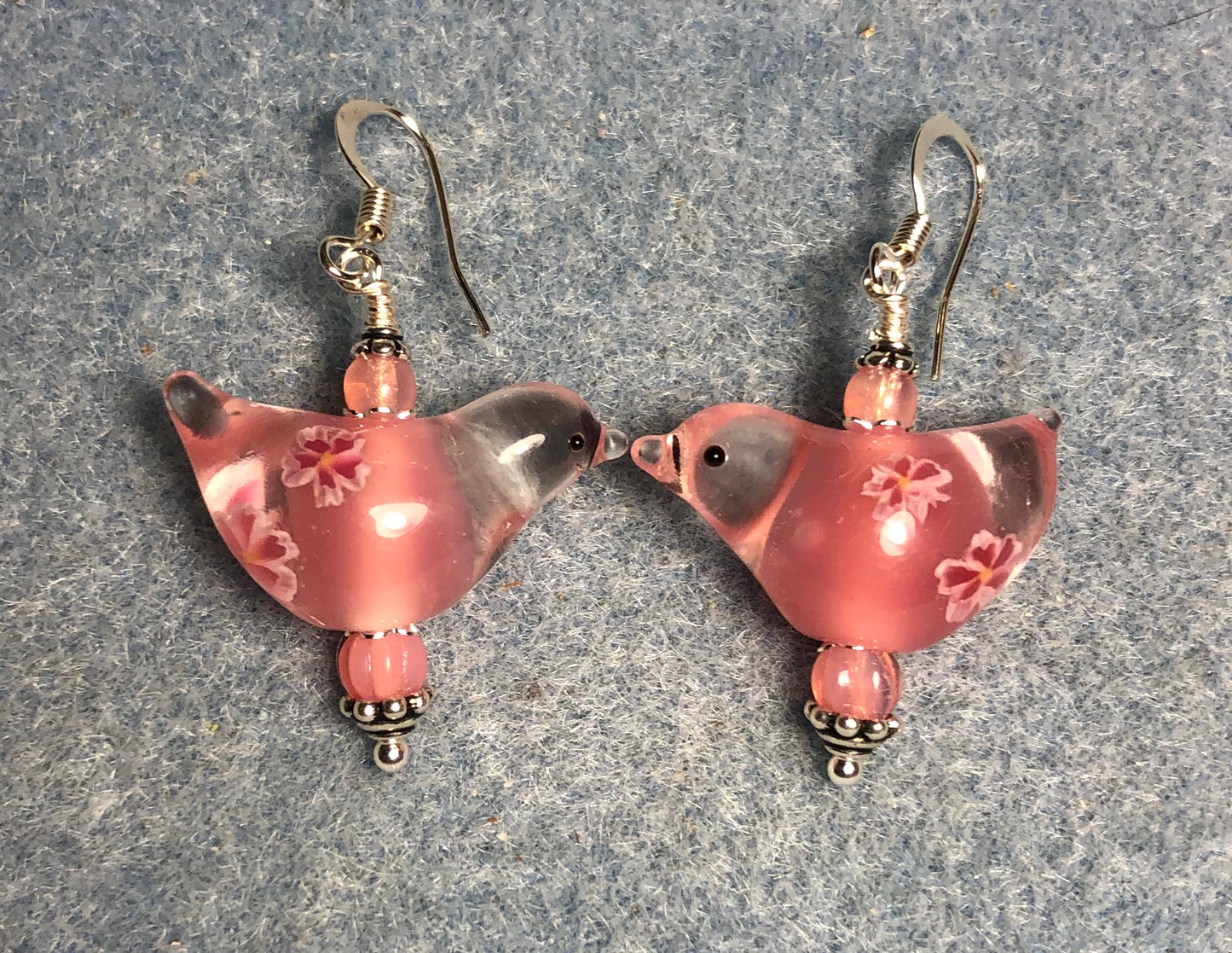Translucent pink lamp work songbird bead earrings adorned with pink Czech glass beads.