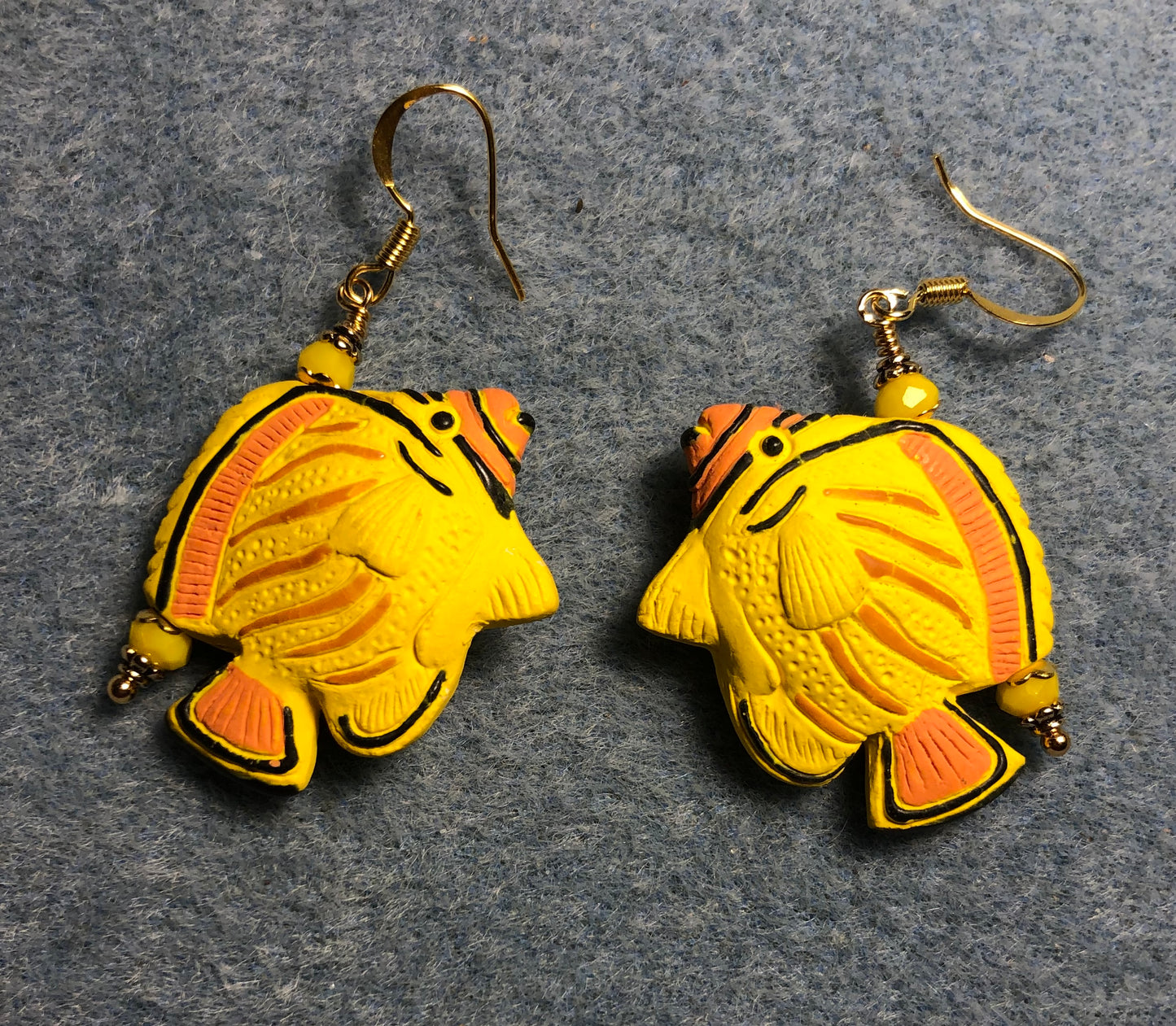 Yellow and orange ceramic striped angelfish bead earrings adorned with golden yellow Chinese crystal beads.
