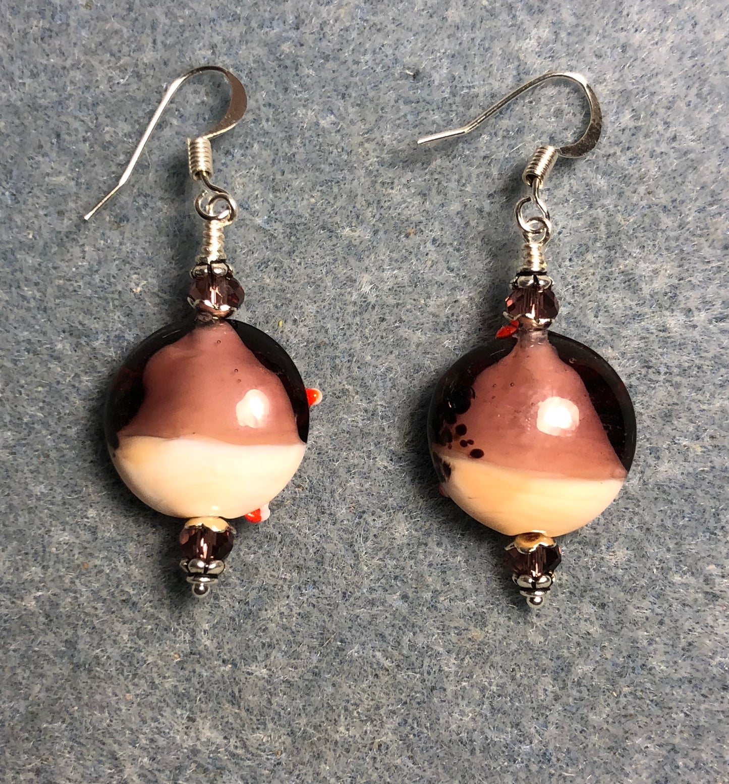 Lavender, red, and tan lamp work starfish bead earrings adorned with lavender Chinese crystal beads.