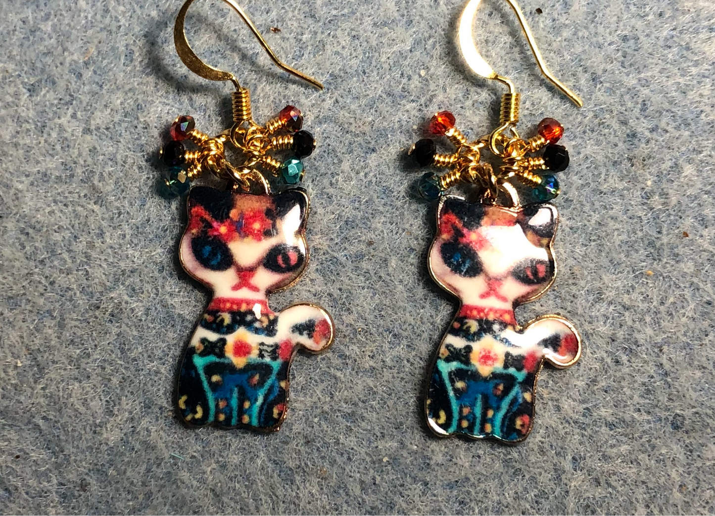 Red, black, and turquoise enamel cat charm earrings adorned with tiny dangling red, black, and turquoise Chinese crystal beads.