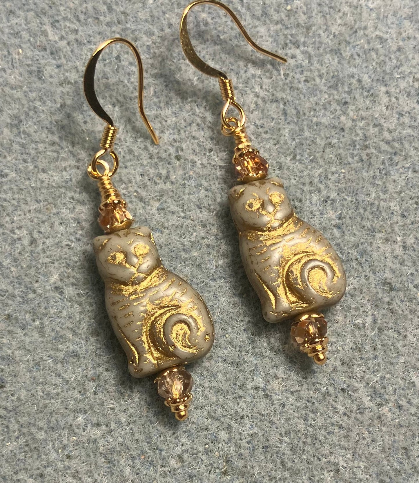Medium off white (with gold inlay) Czech glass cat bead earrings adorned with gold Chinese crystal beads.