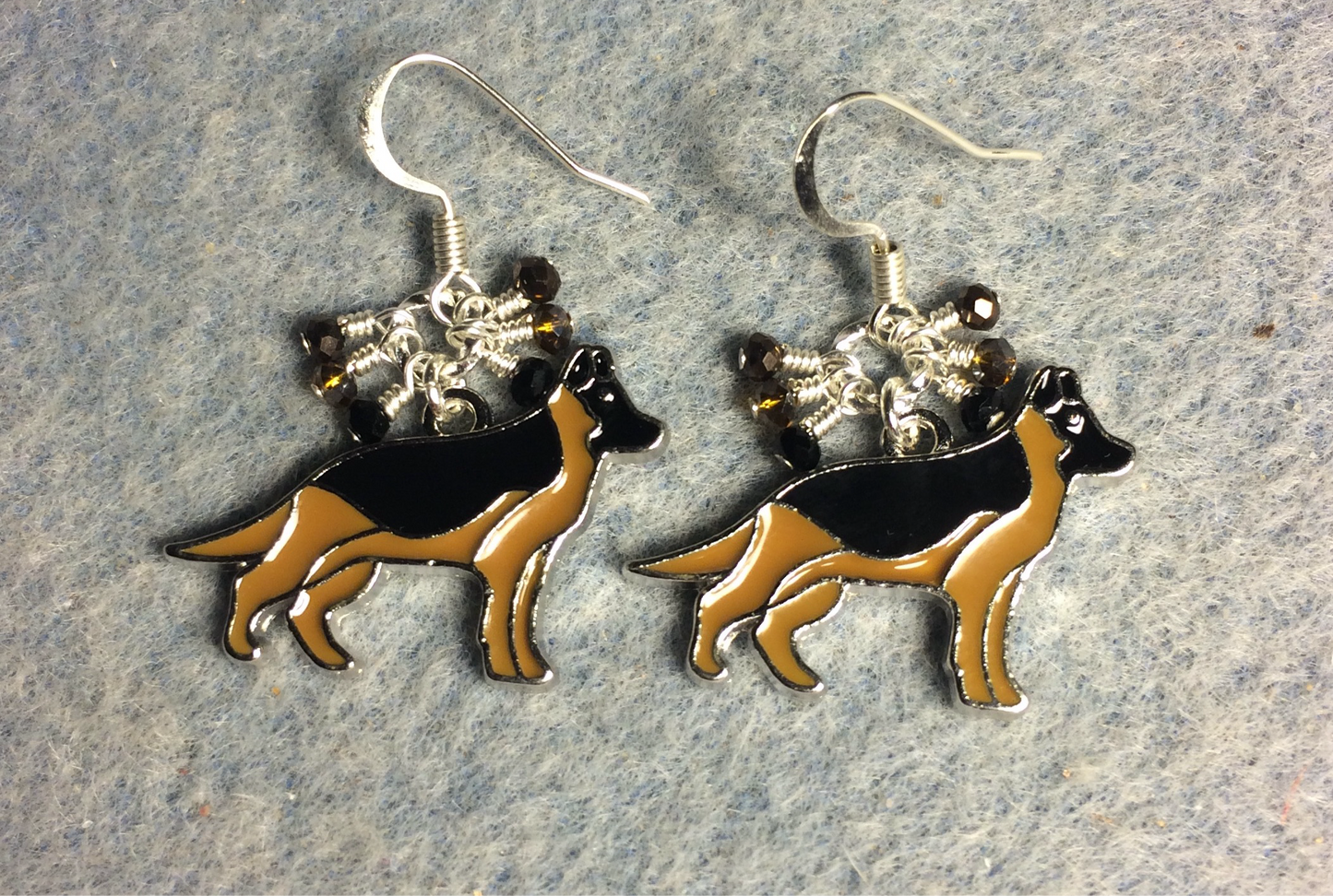 Tan and black enamel German Shepherd charm earrings adorned with tiny dangling black, brown, and amber Chinese crystal beads.