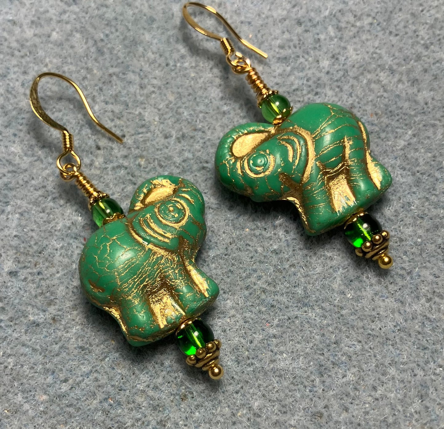 Green (with gold inlay) Czech glass elephant bead earrings adorned with green Czech glass beads.