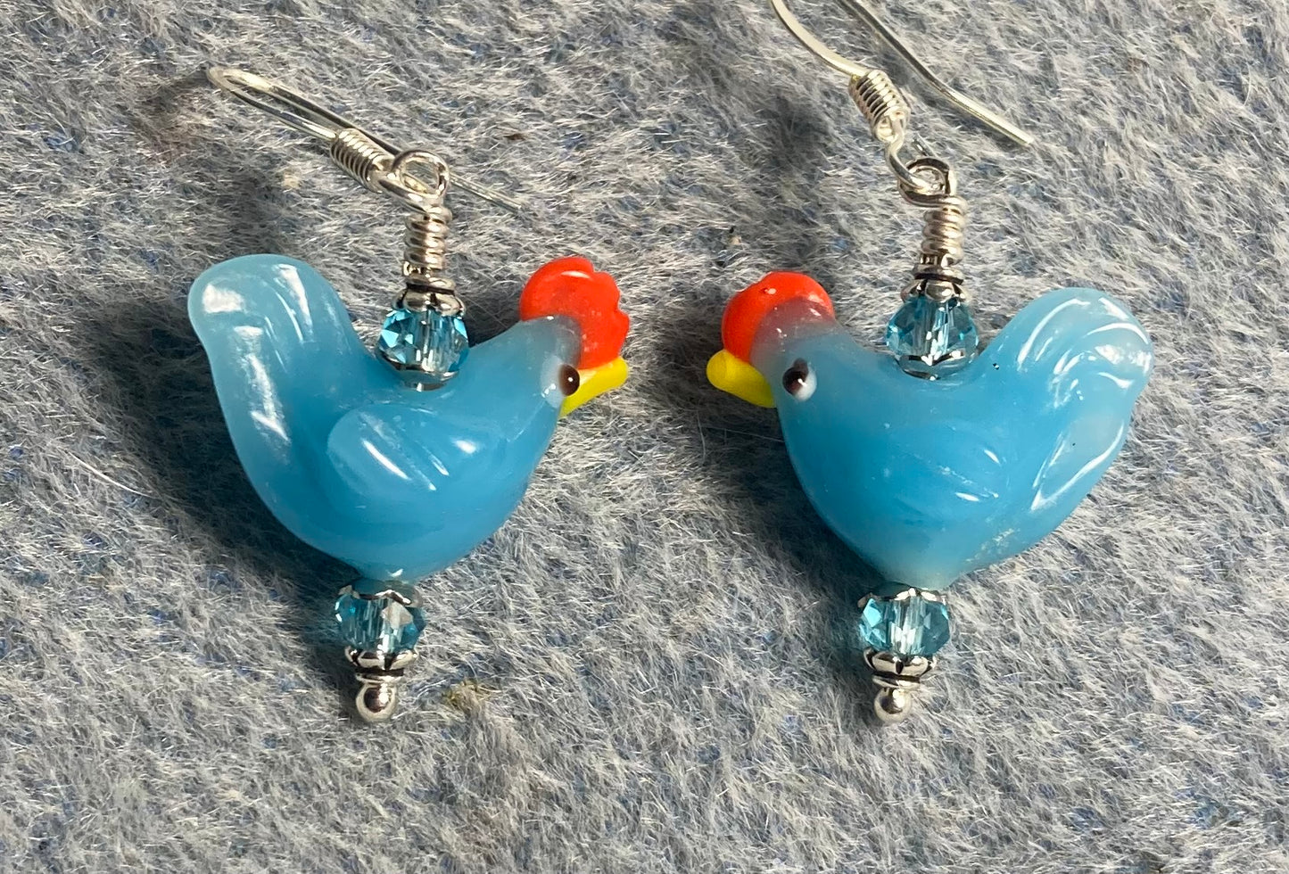 Aqua lamp work chicken bead earrings adorned with light aqua Chinese crystal beads.