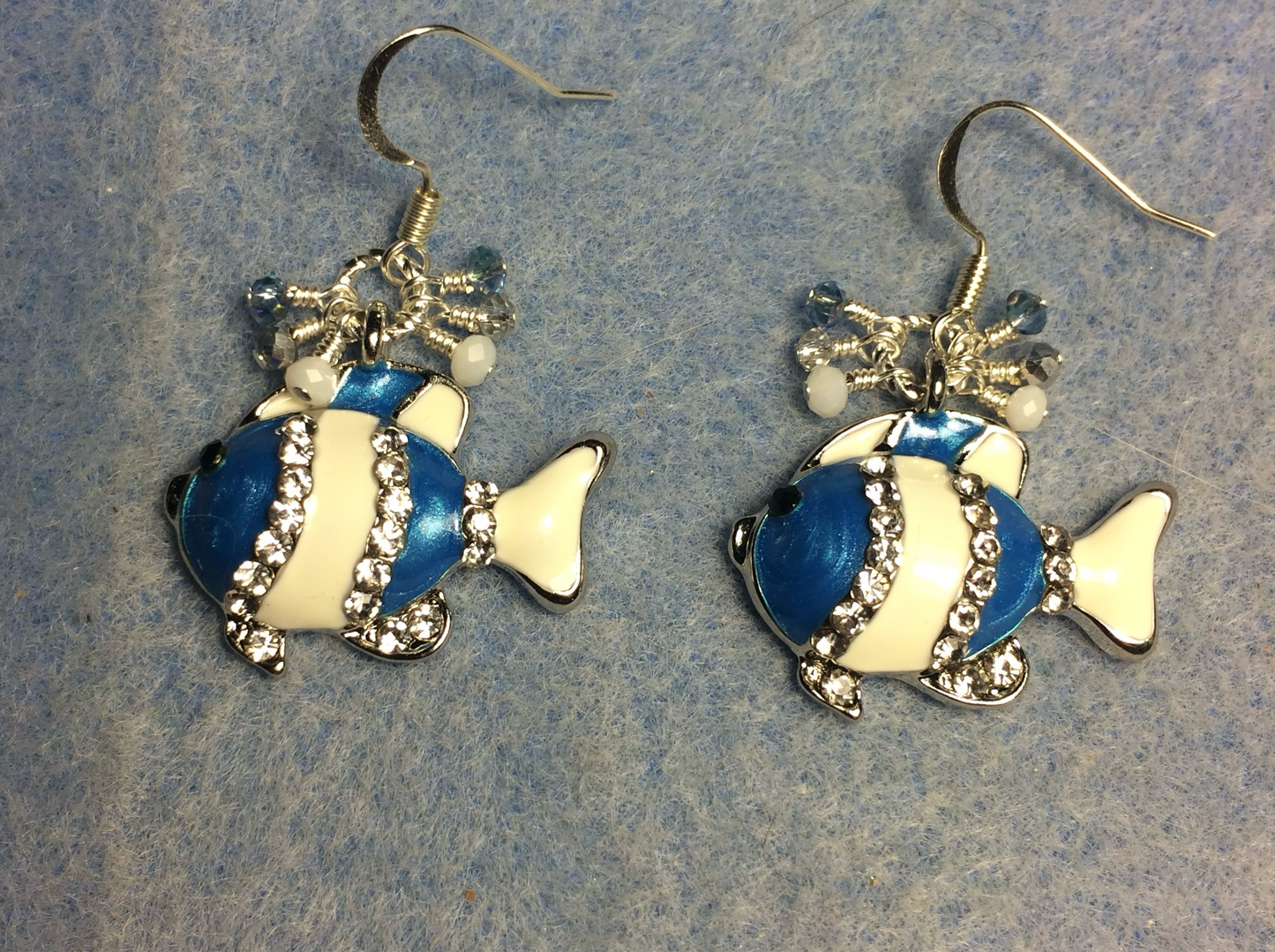 Blue and white enamel and rhinestone striped fish charm earrings adorned with tiny dangling blue, white, and clear Chinese crystal beads.