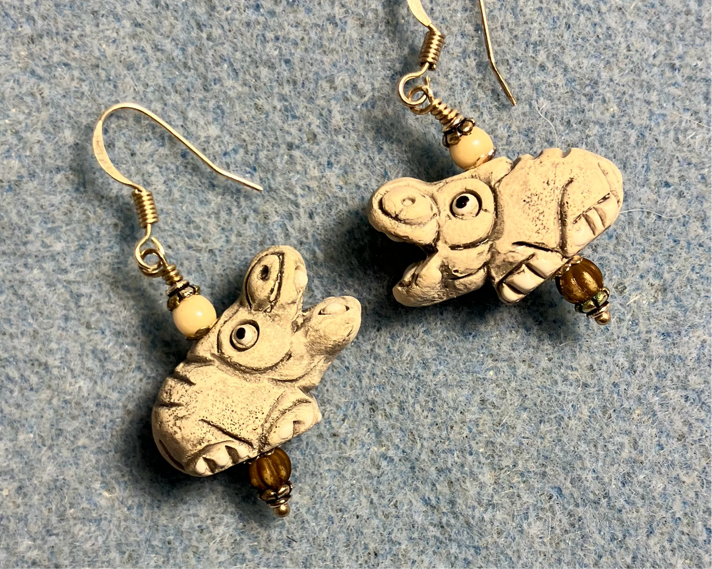 Large off white ceramic hippopotamus bead earrings adorned with off white Czech glass beads.