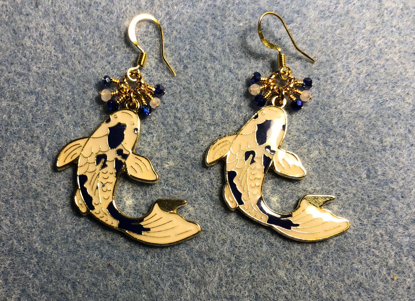 Large blue and white enamel koi charm earrings adorned with tiny dangling dark blue and white Chinese crystal beads.