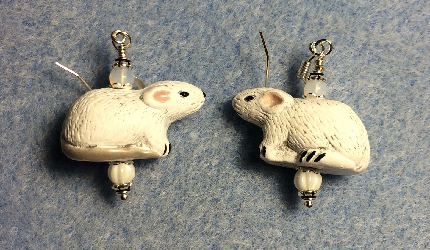 White ceramic mouse bead earrings adorned with white Czech glass beads.