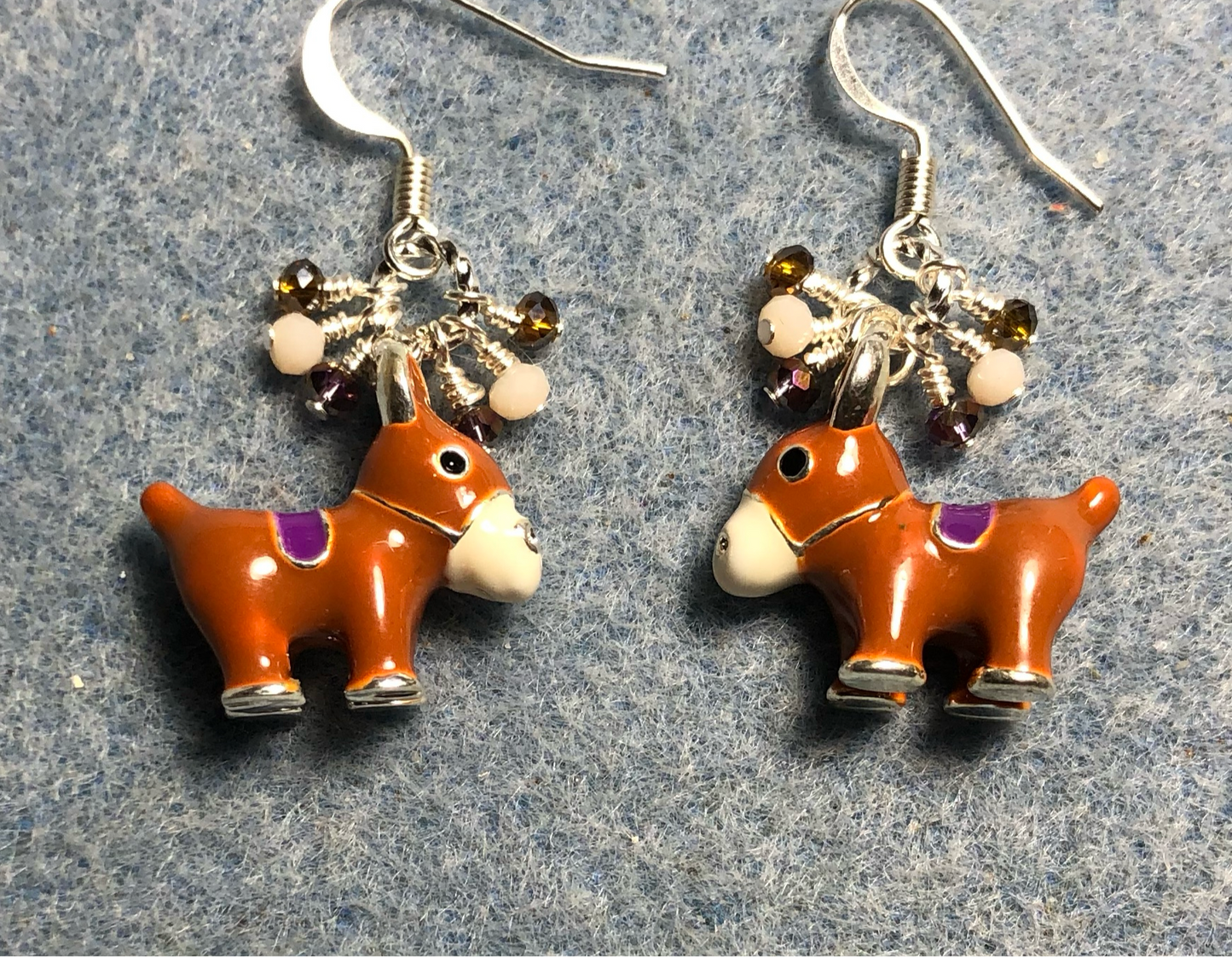 Brown, white, and purple enamel donkey charm earrings adorned with tiny dangling brown, white, and purple Chinese crystal beads.