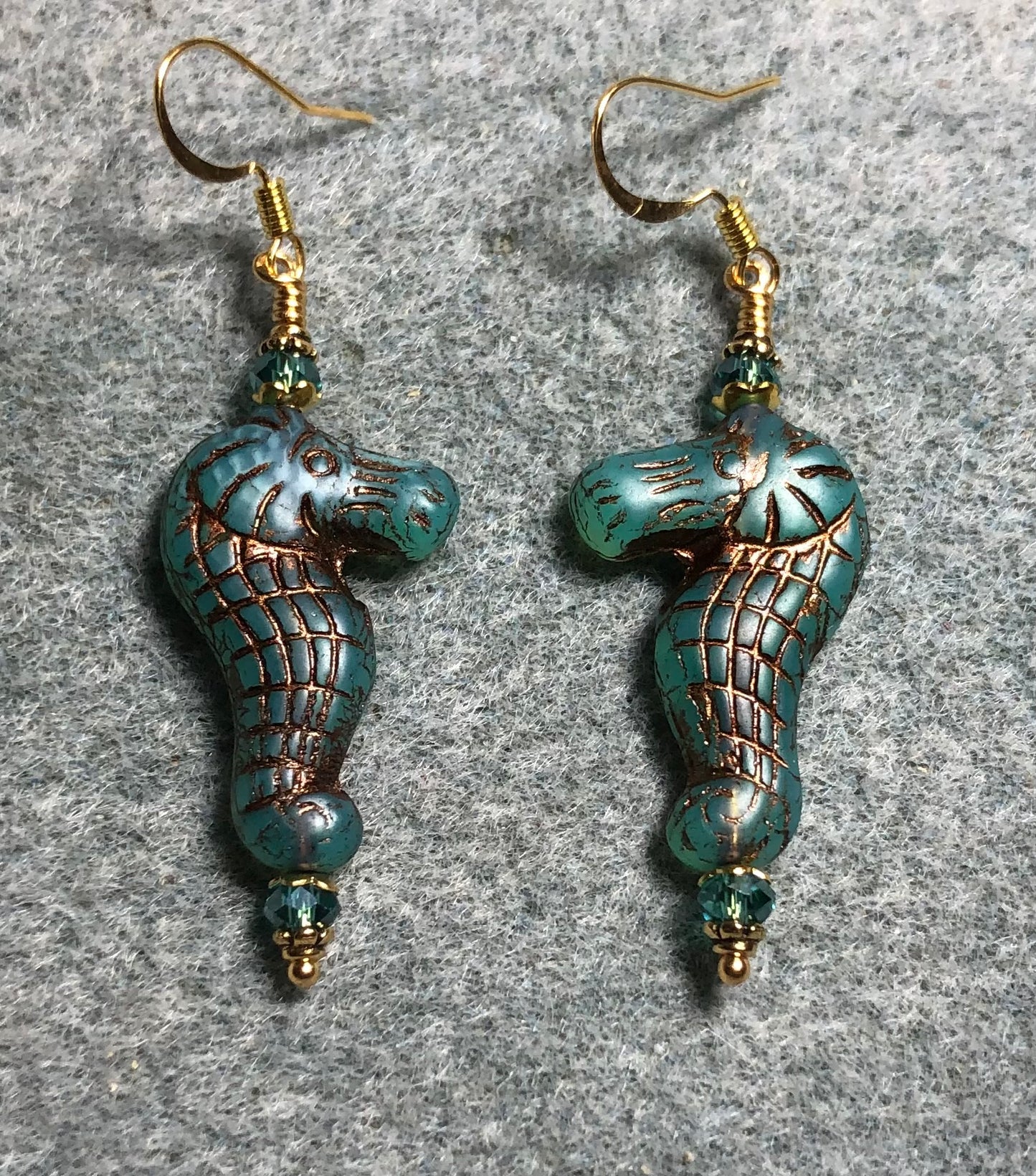 Teal (with copper inlay) Czech glass seahorse bead earrings adorned with teal Chinese crystal beads.