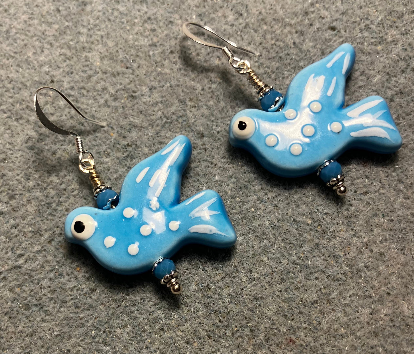 Large turquoise ceramic flying dove bead earrings adorned with turquoise Chinese crystal beads.