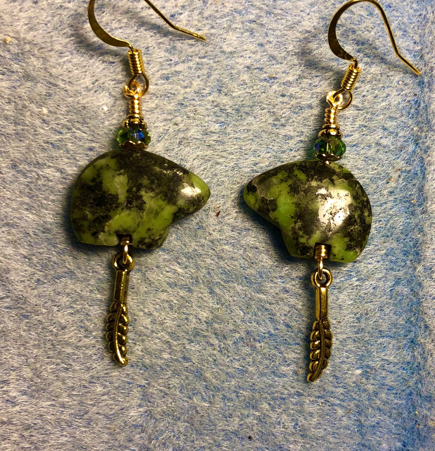 Green African jade gemstone Zuni bear fetish bear earrings adorned with green crystal beads and tiny gold feather charms.