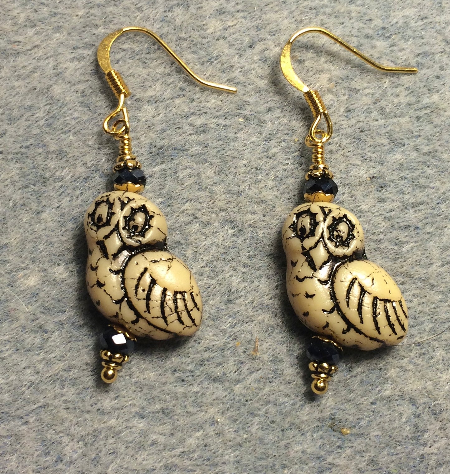 Tan (with black wash) fancy Czech glass owl bead earrings adorned with black Chinese crystal beads.