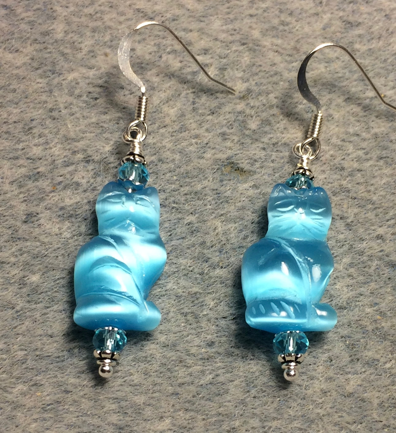 Turquoise fiber optic (cat’s eye) cat bead earrings adorned with turquoise Chinese crystal beads.