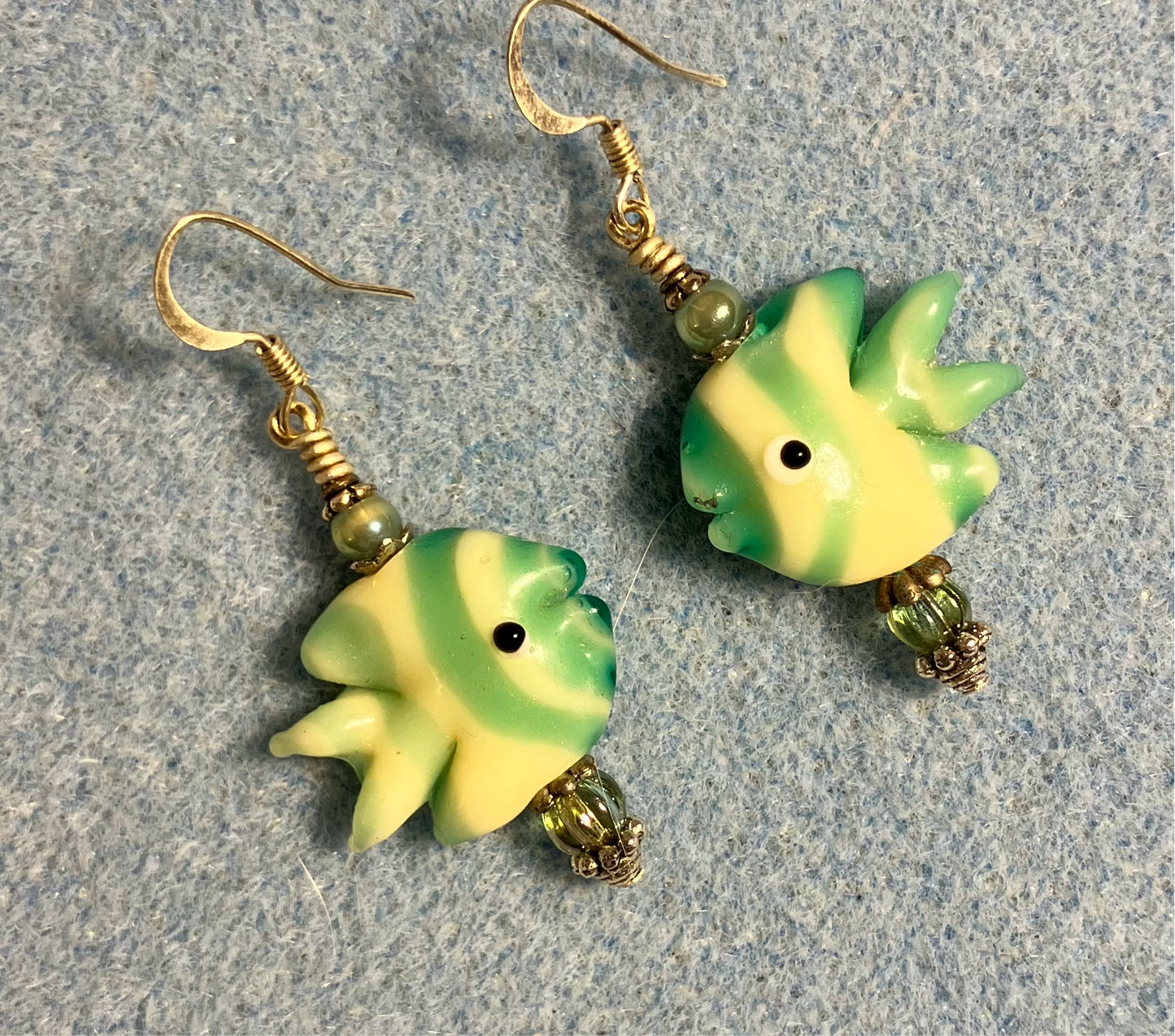 Light green and yellow lamp work striped angelfish bead earrings adorned with light green Czech glass beads.