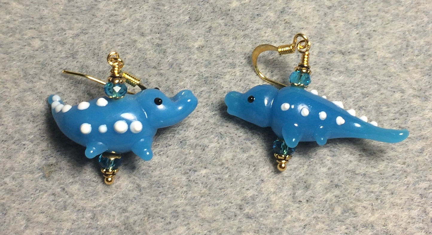 Opaque turquoise lamp work spotted alligator bead earrings adorned with turquoise Chinese crystal beads.