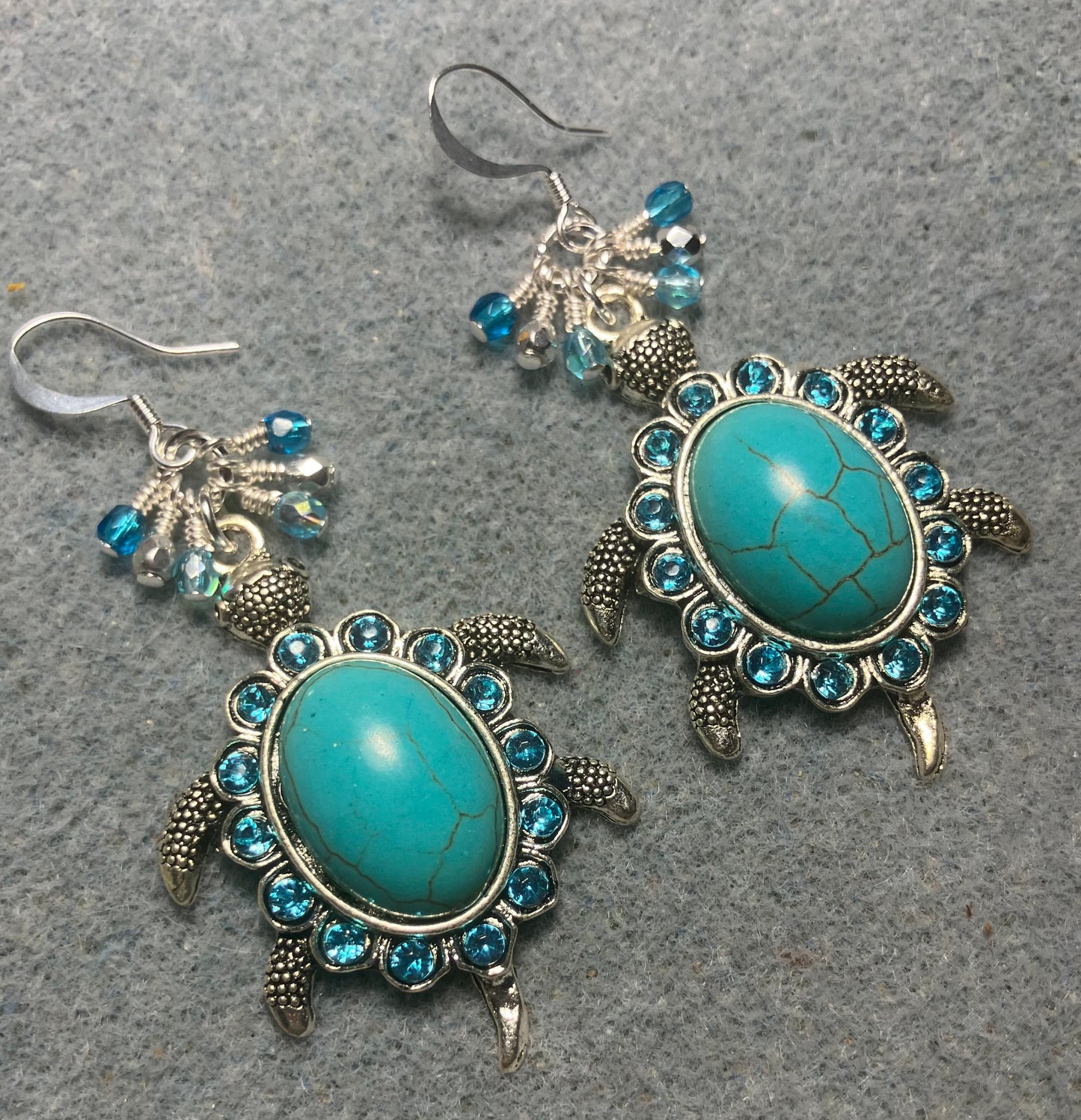 Large silver and turquoise gemstone and rhinestone turtle charm earrings adorned with small dangling turquoise and silver Czech glass beads.