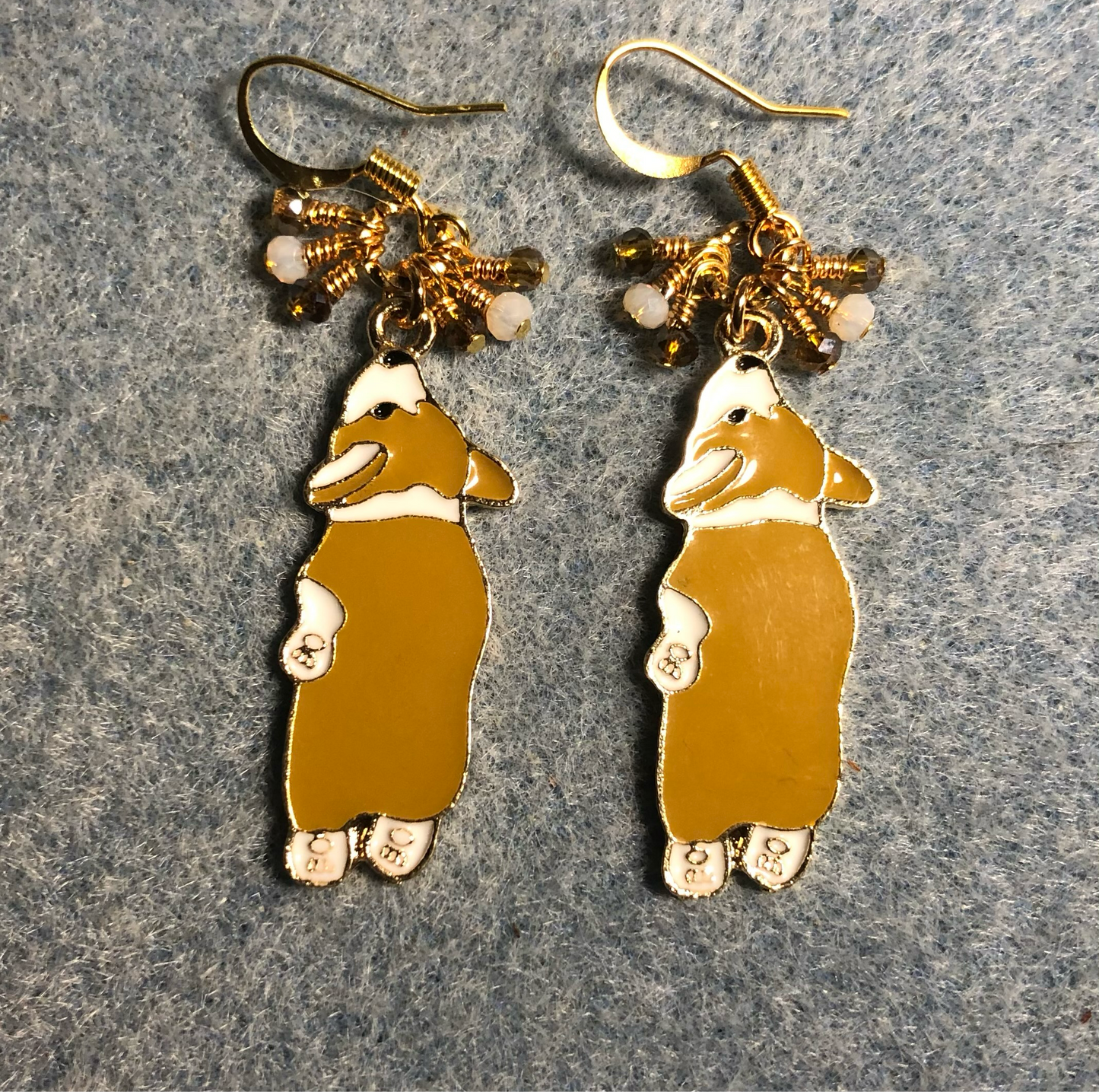 Tan and white enamel sleeping corgi charm earrings adorned with tiny dangling tan and white Chinese crystal beads.