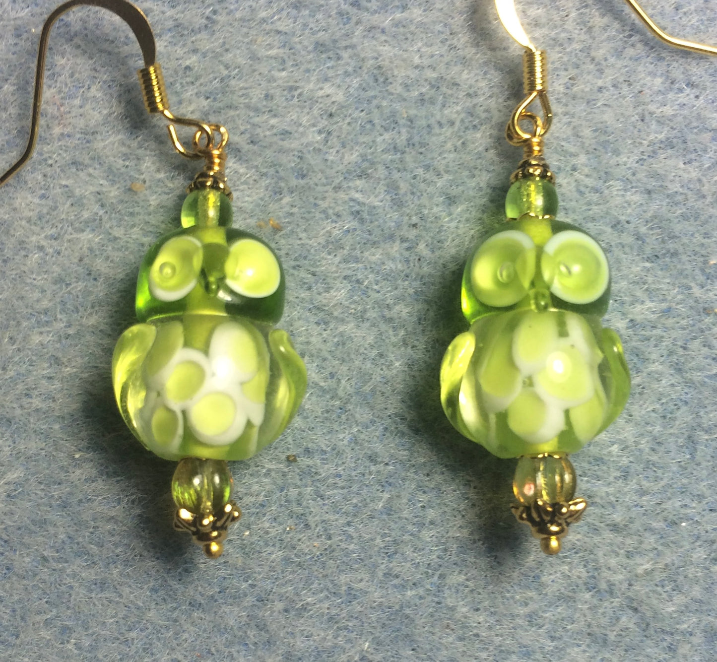 Lime green lamp work owl bead earrings adorned with lime green Czech glass beads.