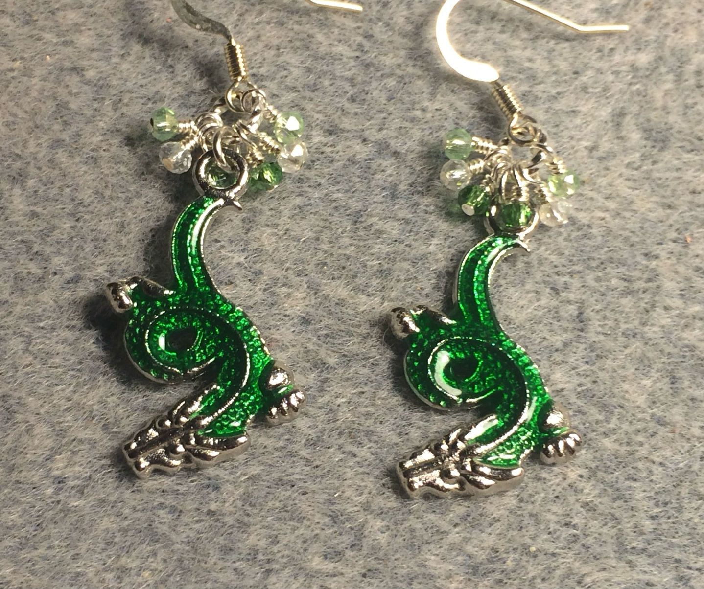 Silver and green enamel dragon charm earrings adorned with tiny dangling green and silver Chinese crystal beads.