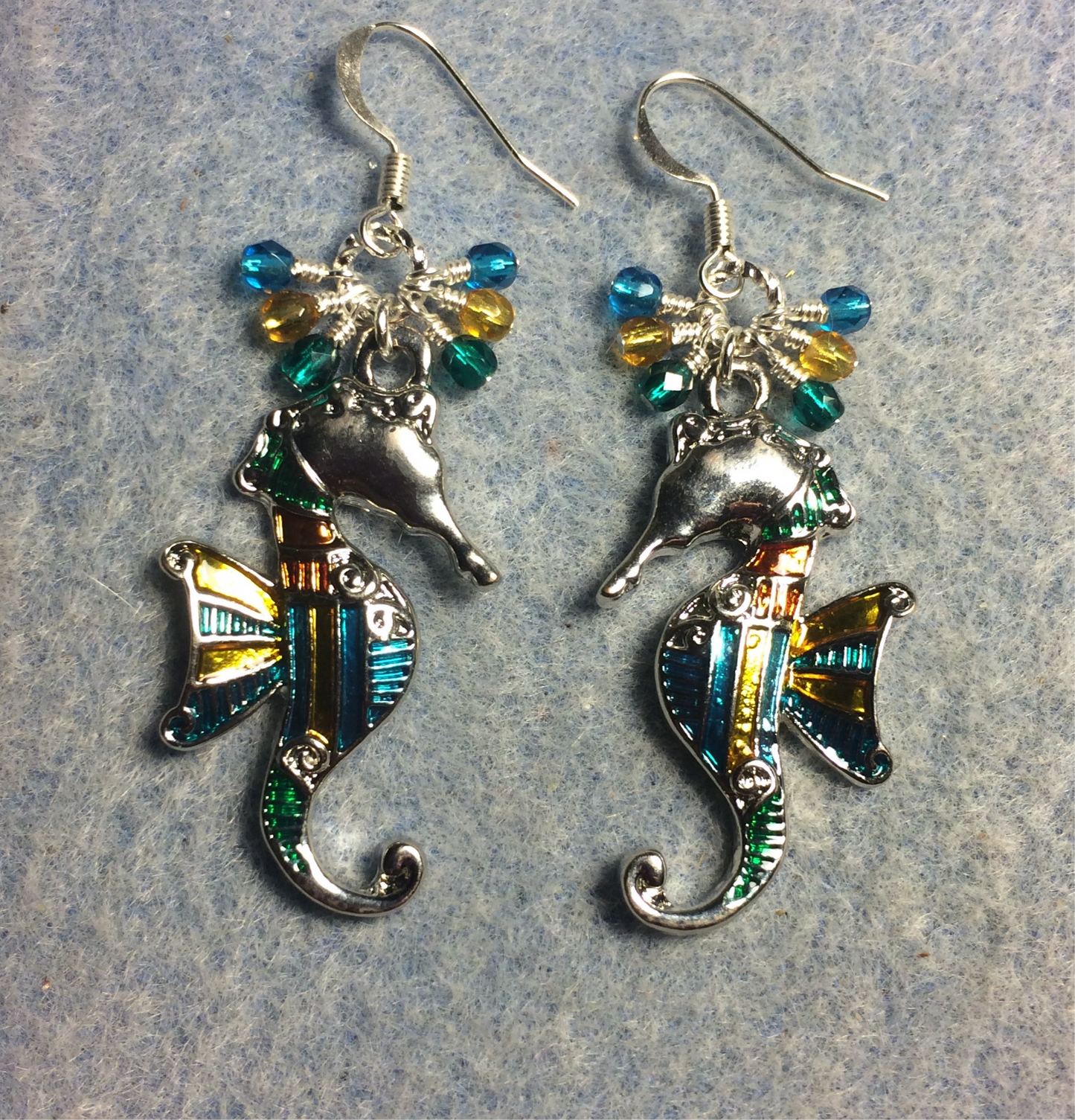 Large turquoise, amber, and teal enamel seahorse charm earrings adorned with small dangling turquoise, amber, and teal Czech glass beads.