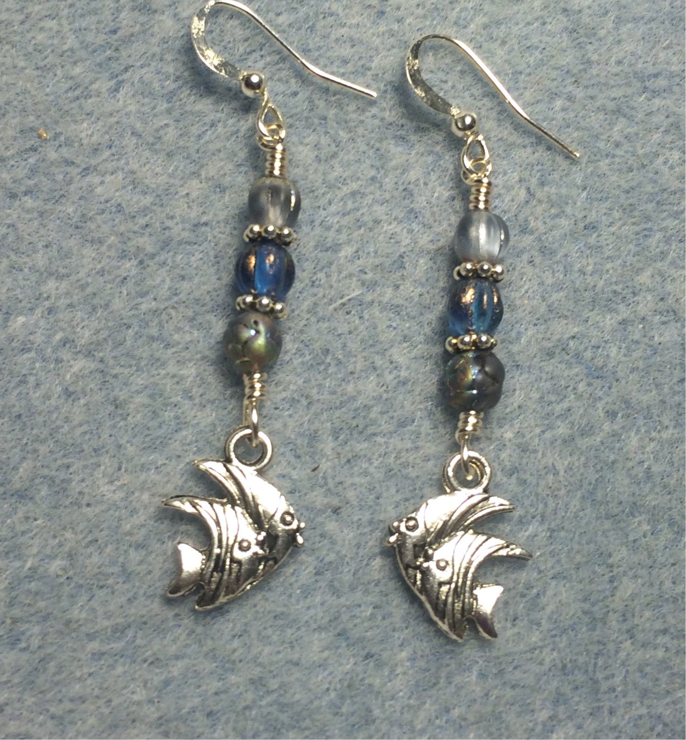Small silver angelfish charm earrings adorned with small light blue Czech glass beads