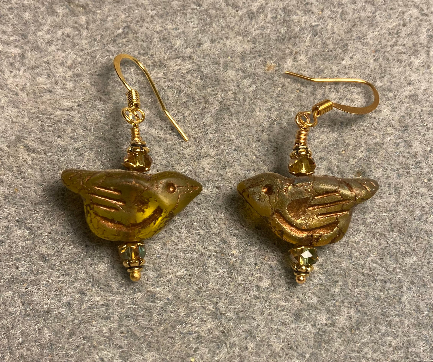 Olive green (with gold wash) Czech glass bird bead earrings adorned with olive green Chinese crystal beads.