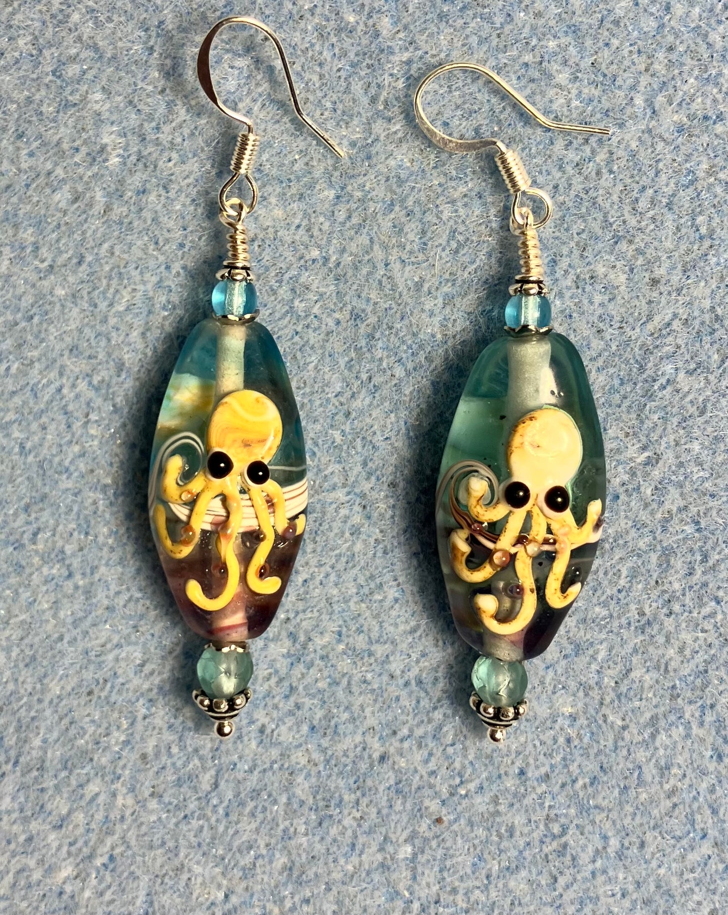 Light aqua and tan lamp work octopus bead earrings adorned with light aqua Chinese crystal beads.