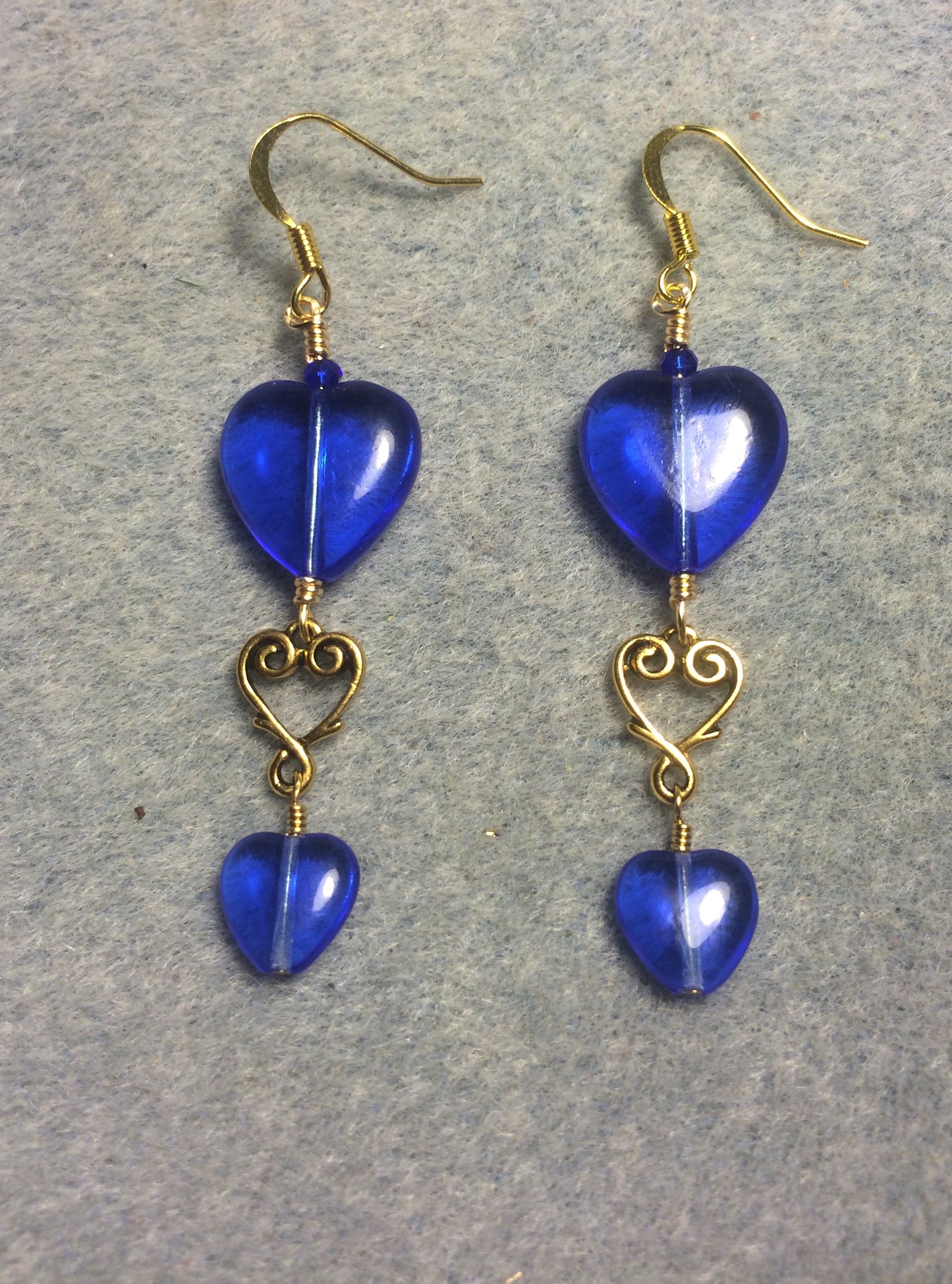 Large and small matching bright blue Czech glass heart bead earrings joined by gold Tierracast heart connectors.