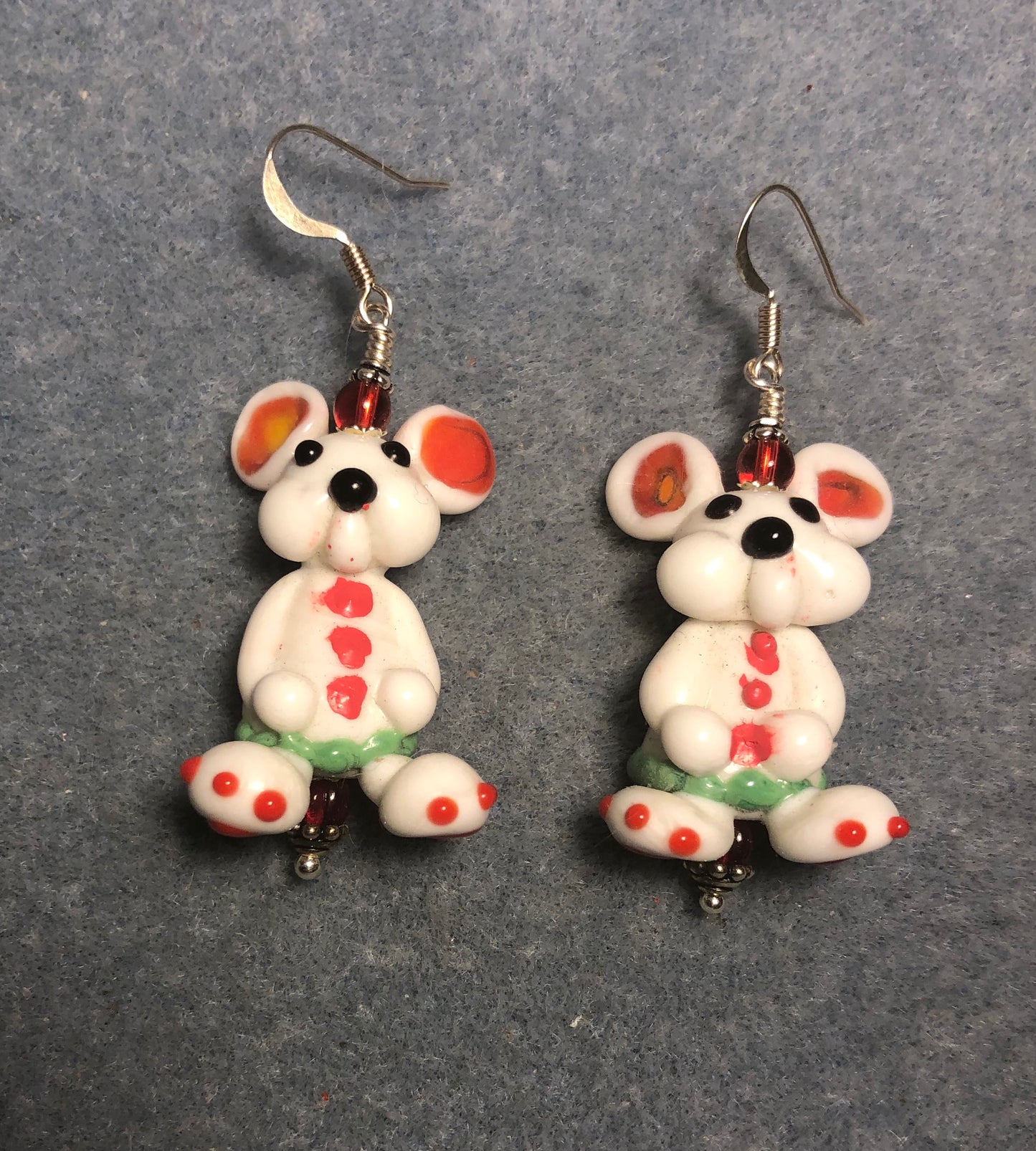 Large white, red, and green lamp work bunny rabbit bead earrings adorned with red Czech glass beads.
