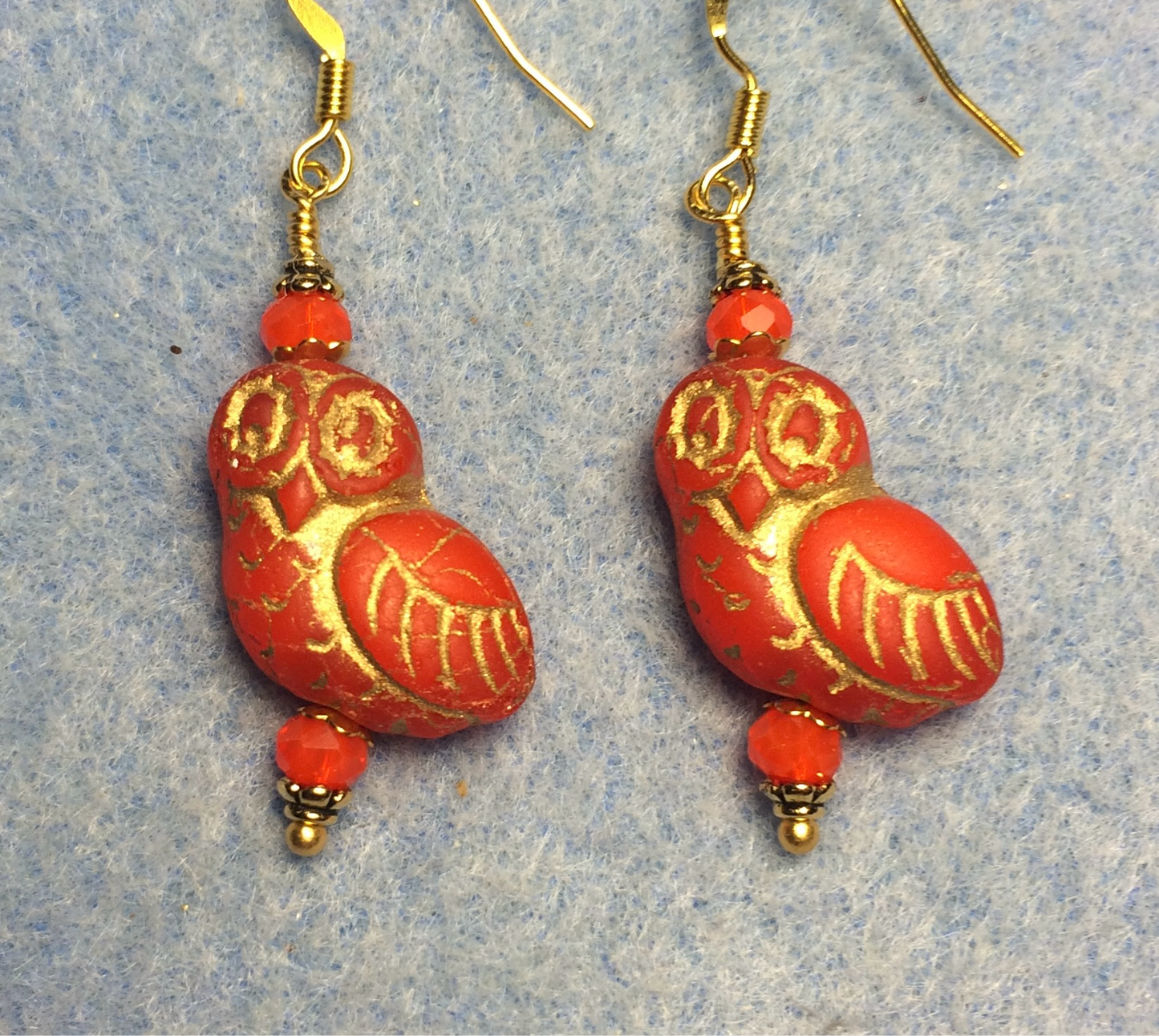Reddish orange (with gold wash) fancy Czech glass owl bead earrings adorned with orange Chinese crystal beads.