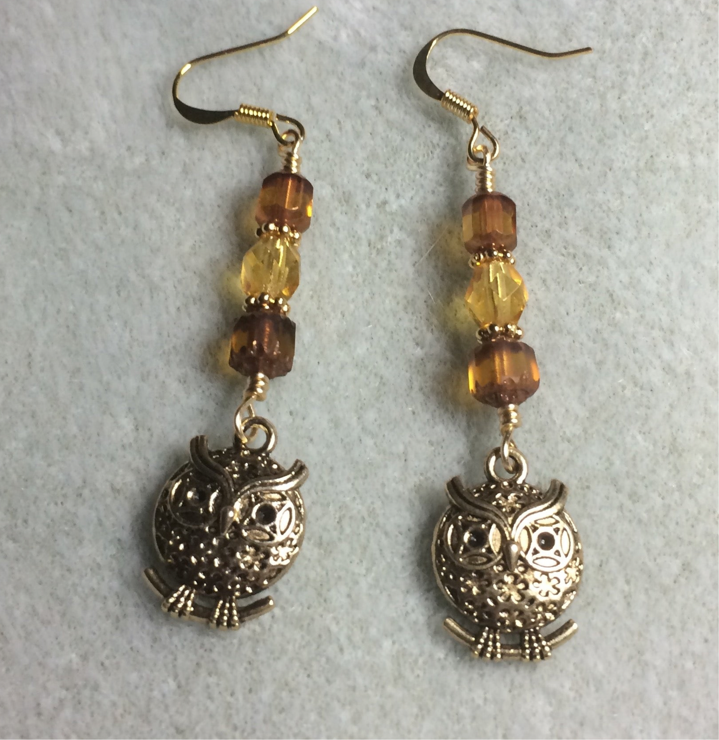 Fancy gold owl charm earrings adorned with amber Czech glass beads
