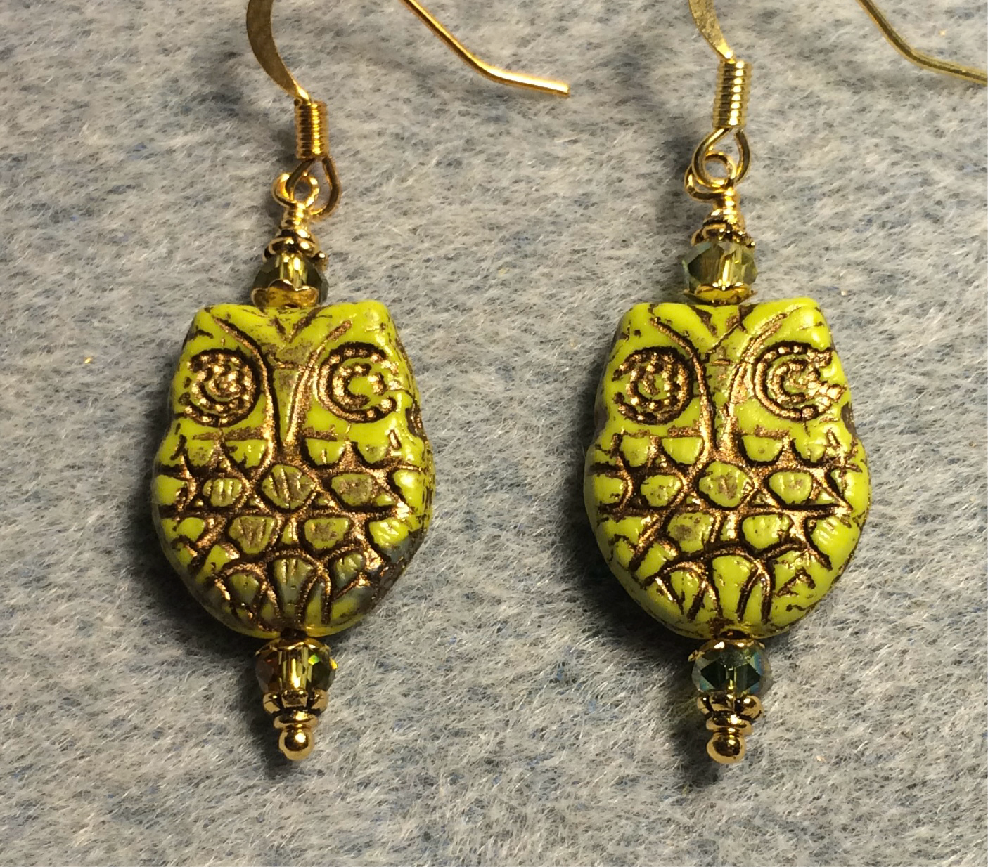 Lime green (with gold wash) Czech glass owl bead earrings adorned with lime green Chinese crystal beads.