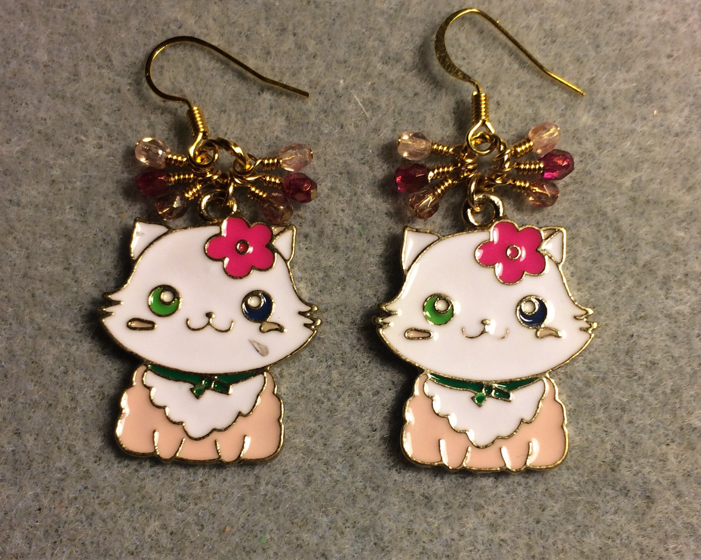 Pink and white enamel cat charm earrings adorned with small dangling light pink and hot pink Czech glass beads.
