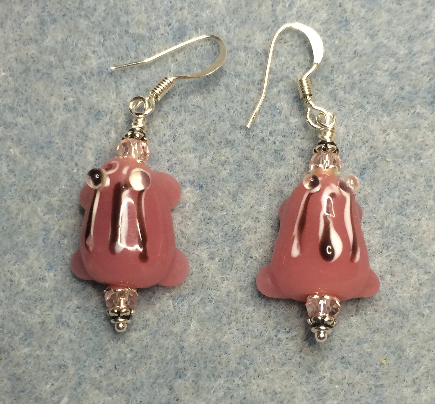 Pink with black stripes lamp work frog bead earrings adorned with pink Chinese crystal beads.