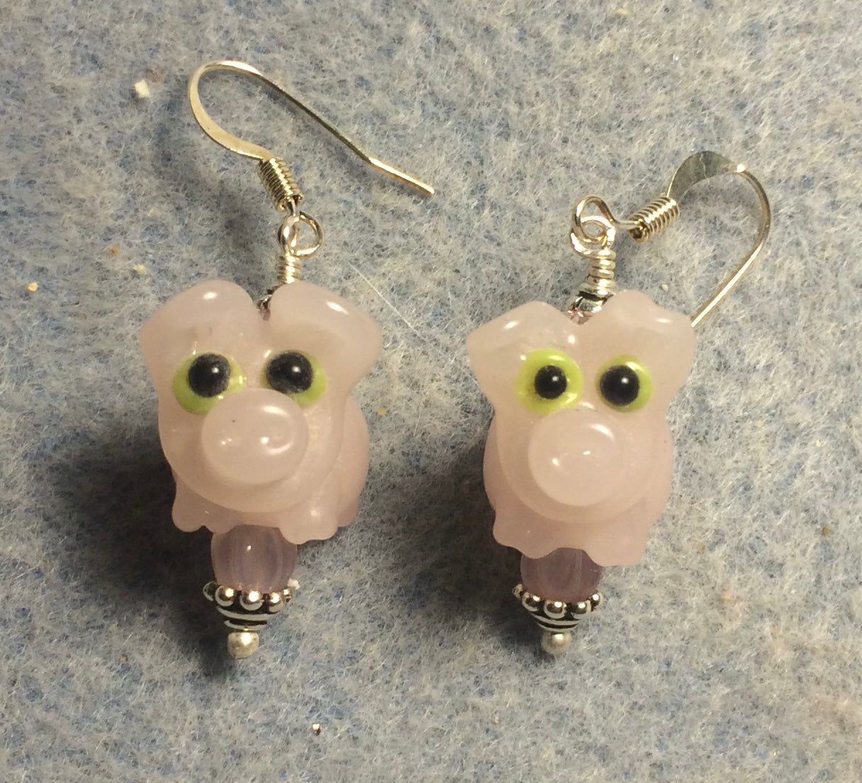 Light pink lamp work pig bead earrings adorned with pink Czech glass beads.