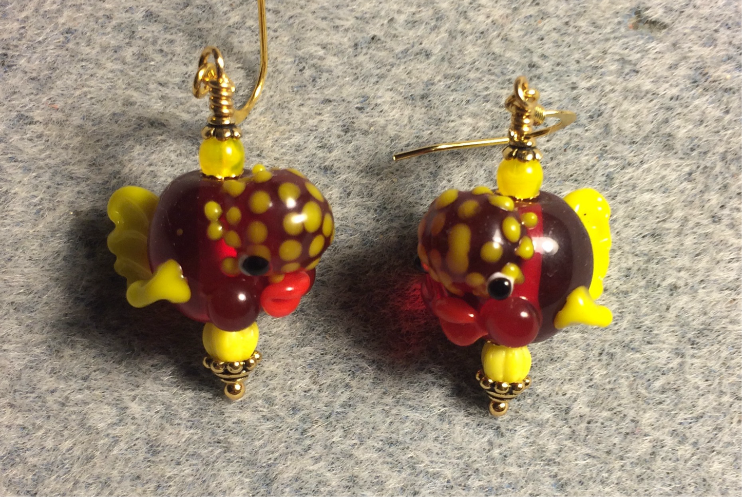 Translucent dark red and yellow lamp work clownfish bead earrings adorned with yellow Czech glass beads.