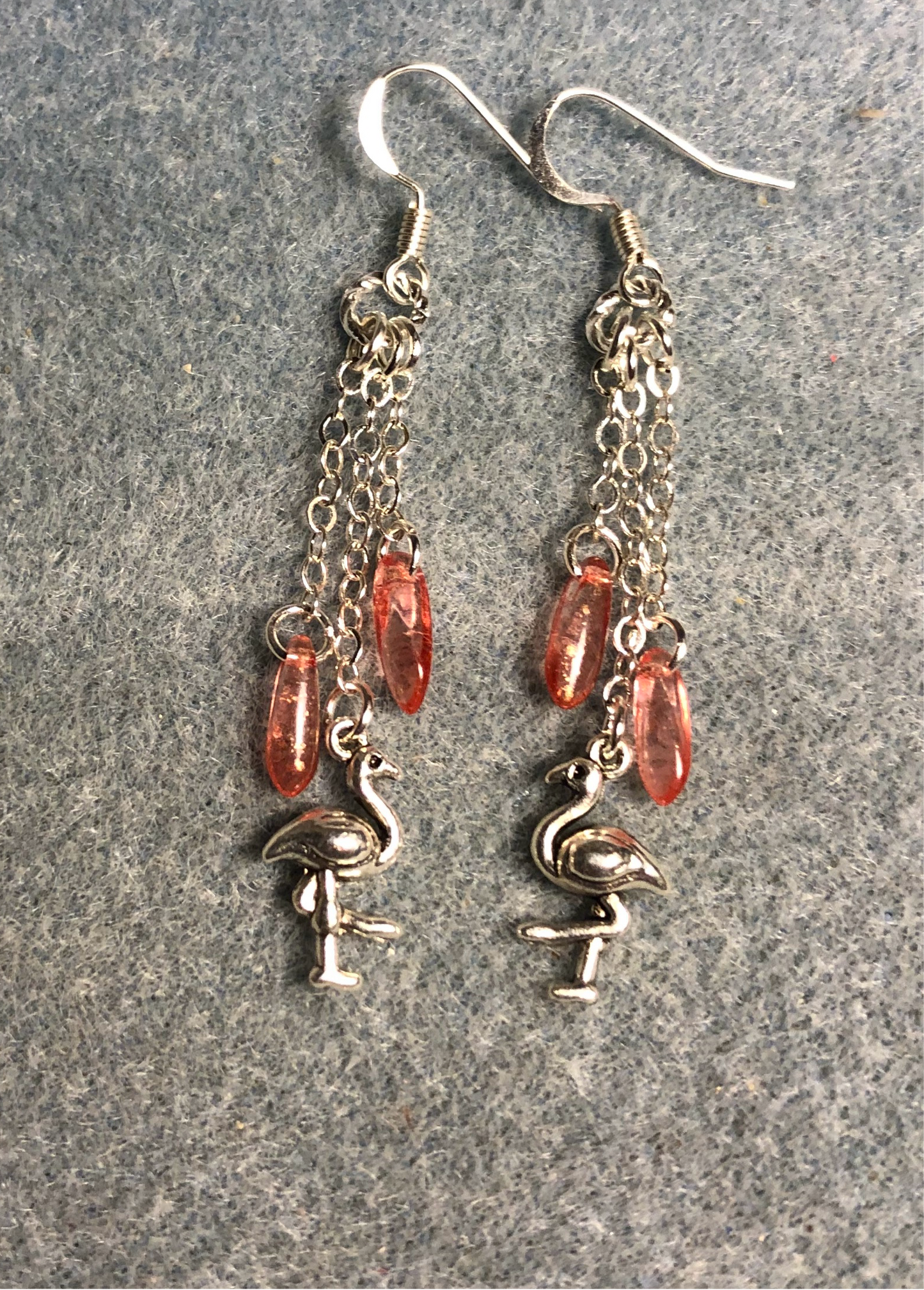 Small silver flamingo charm earrings attached to silver chain and adorned with small pink Czech glass dagger beads