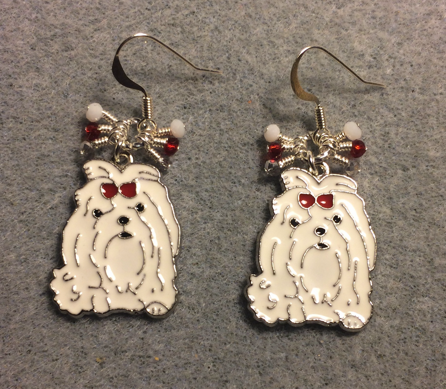 White and red enamel Shih Tzu dog charm earrings adorned with tiny dangling white, silver, and red Chinese crystal beads.