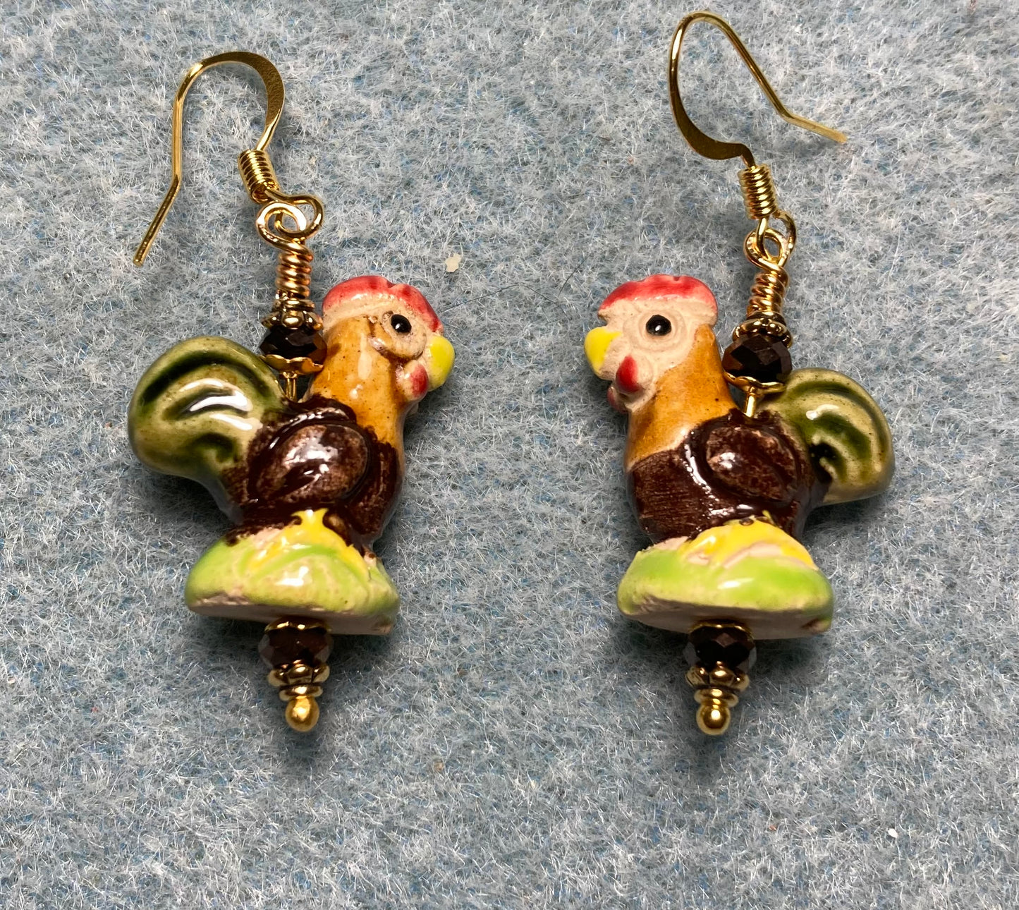 Small olive green, brown, and orange ceramic chicken bead earrings adorned with brown Chinese crystal beads.
