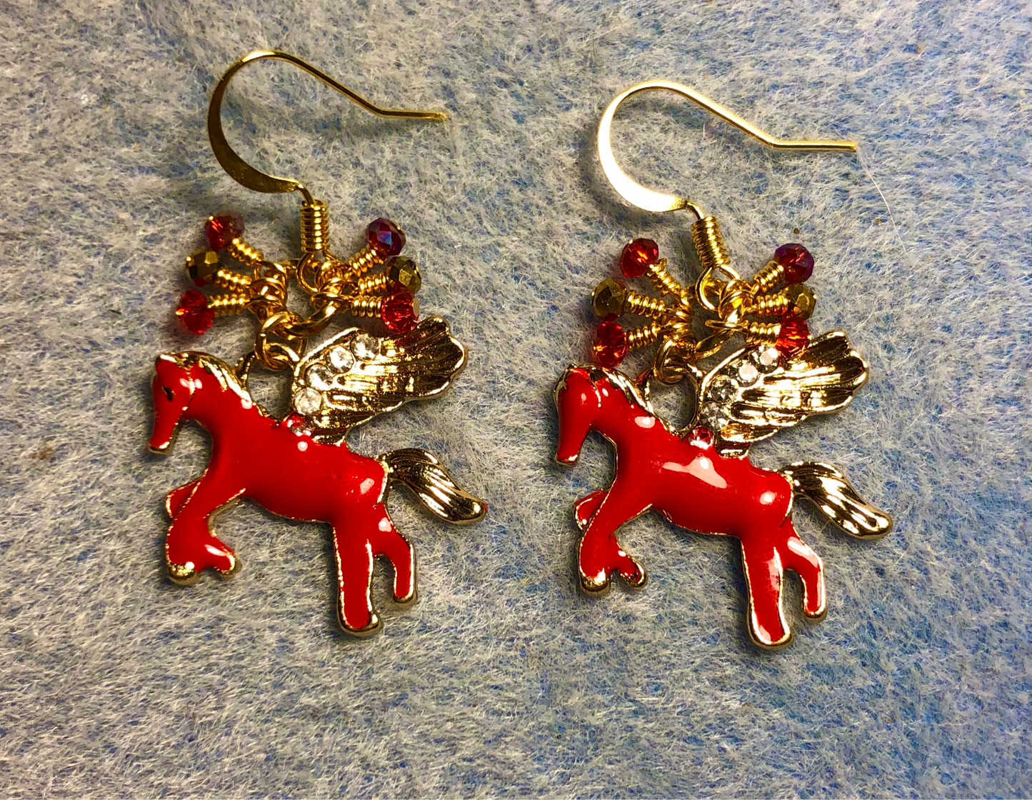 Red and gold enamel and rhinestone Pegasus (flying horse) charm earrings adorned with tiny dangling red and gold Chinese crystal beads.
