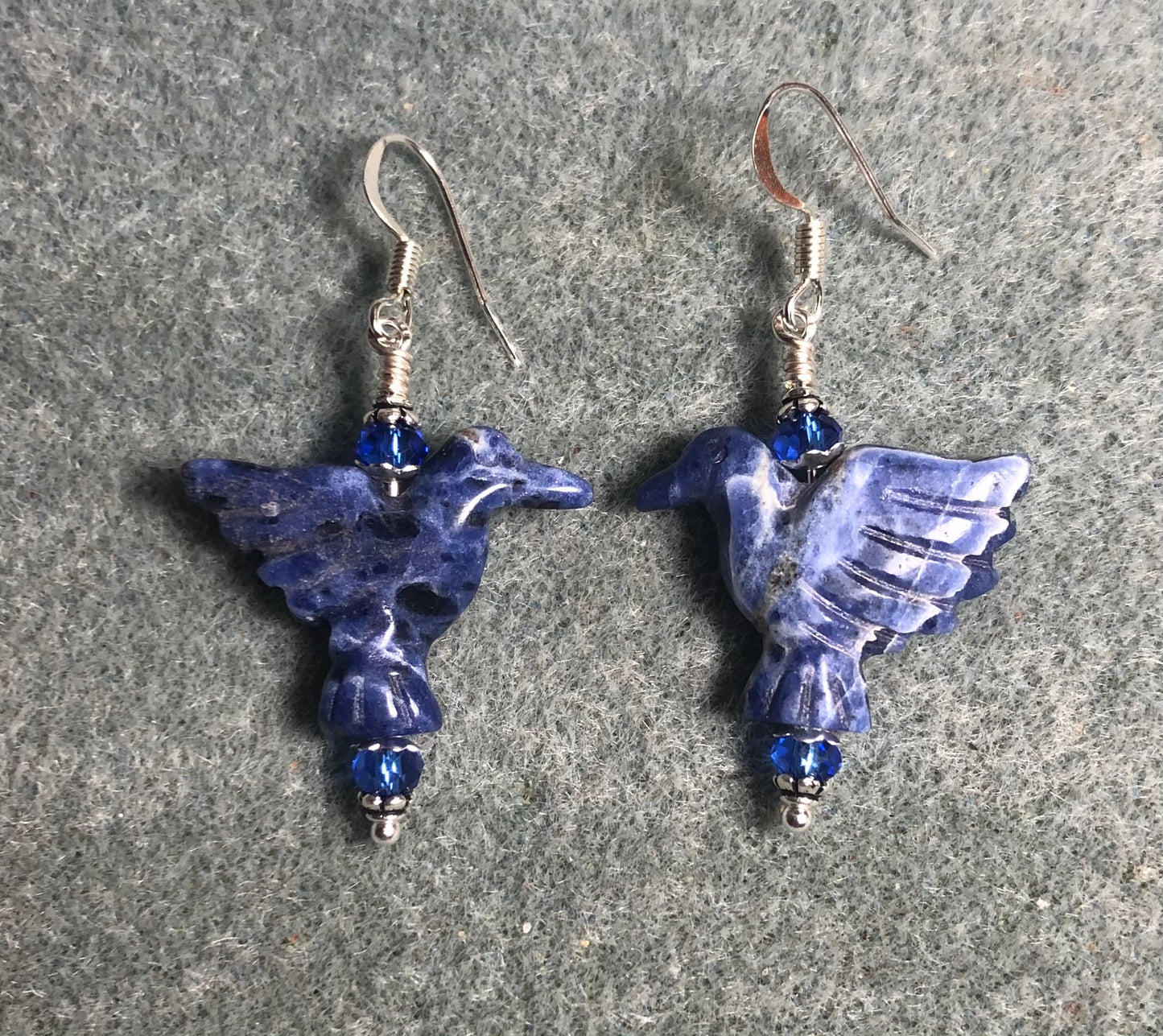 Blue sodalite gemstone flying eagle bead earrings adorned with blue Chinese crystal beads.
