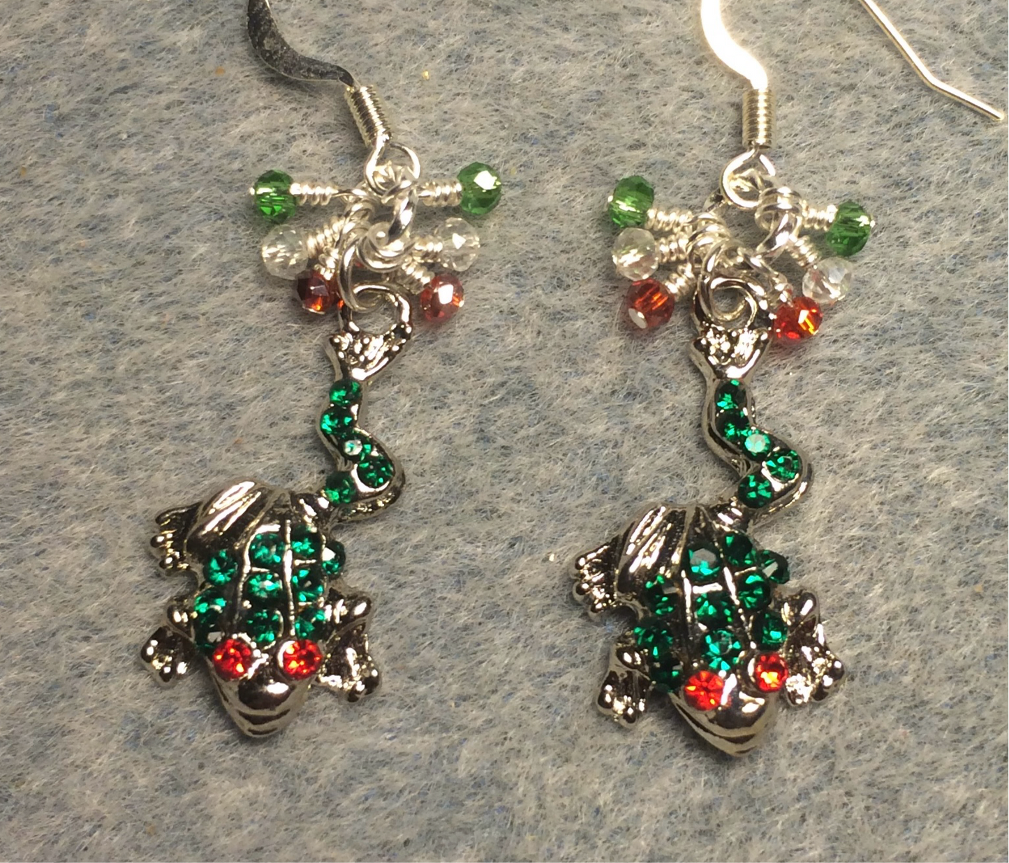Silver, green, and red rhinestone frog charm earrings adorned with tiny dangling green, clear, and red Chinese crystal beads.