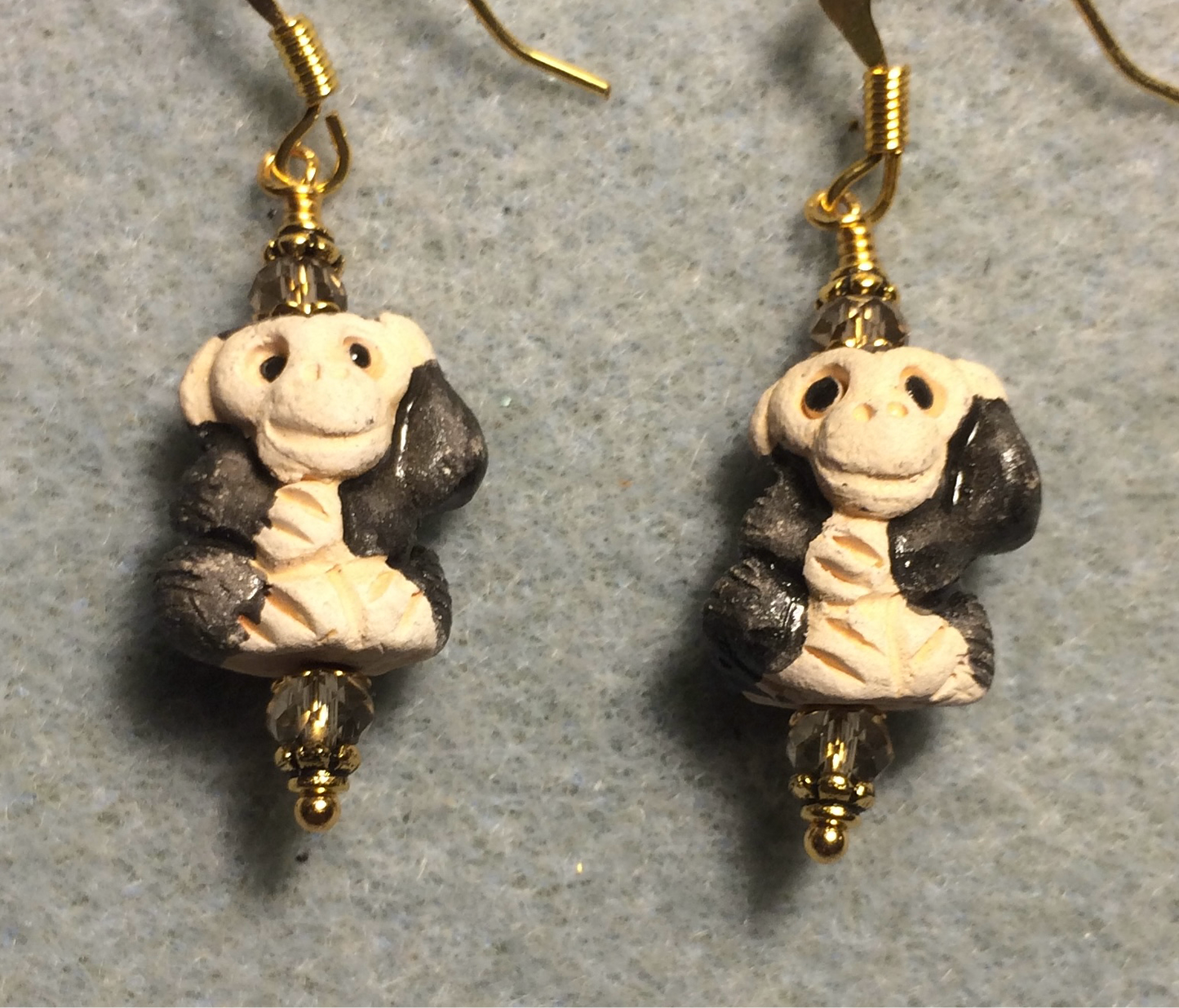 Small black and gray ceramic chimpanzee bead earrings adorned with gray Chinese crystal beads.
