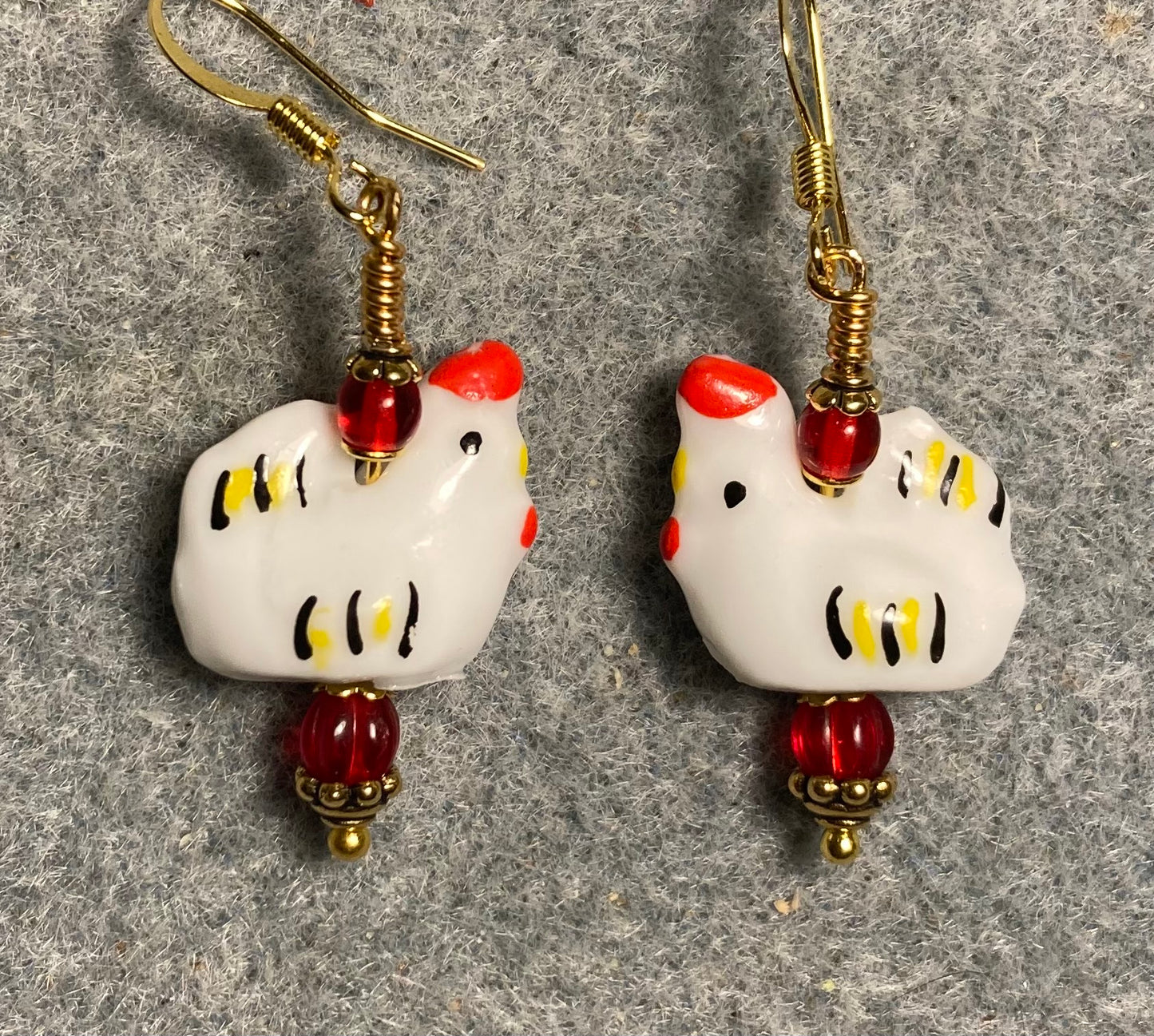 White, red, and yellow ceramic chicken bead earrings adorned with red Czech glass beads.