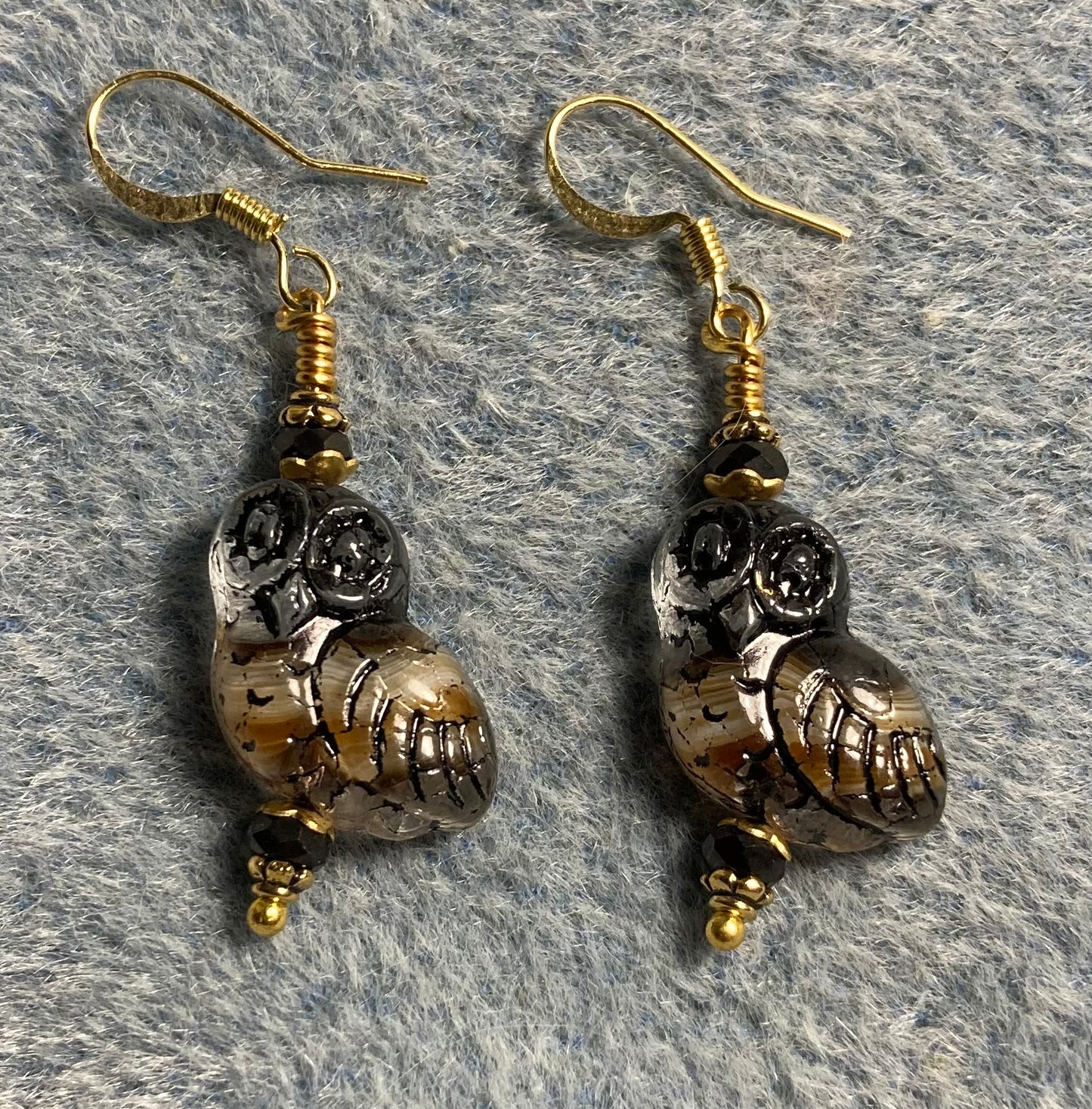 Brown, beige, and black fancy Czech glass owl bead earrings adorned with brown Chinese crystal beads.