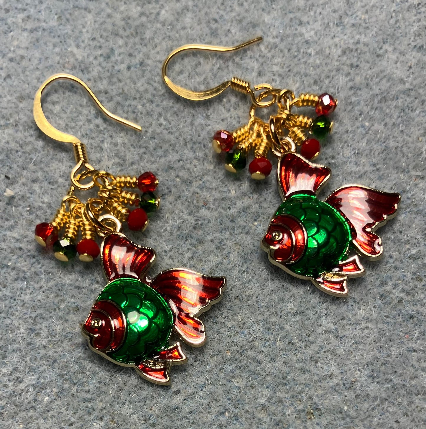 Red and green enamel angelfish charm earrings adorned with tiny dangling red and green Chinese crystal beads.