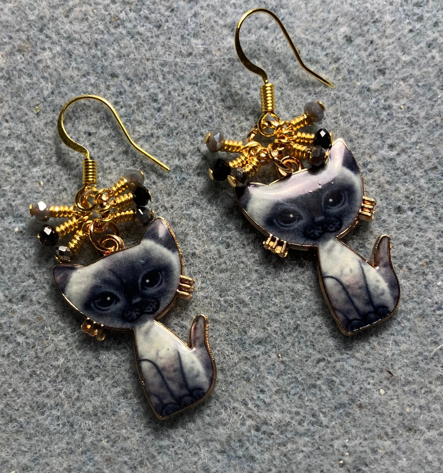 Gray and black enamel cat charm earrings adorned with tiny dangling gray and black Chinese crystal beads.
