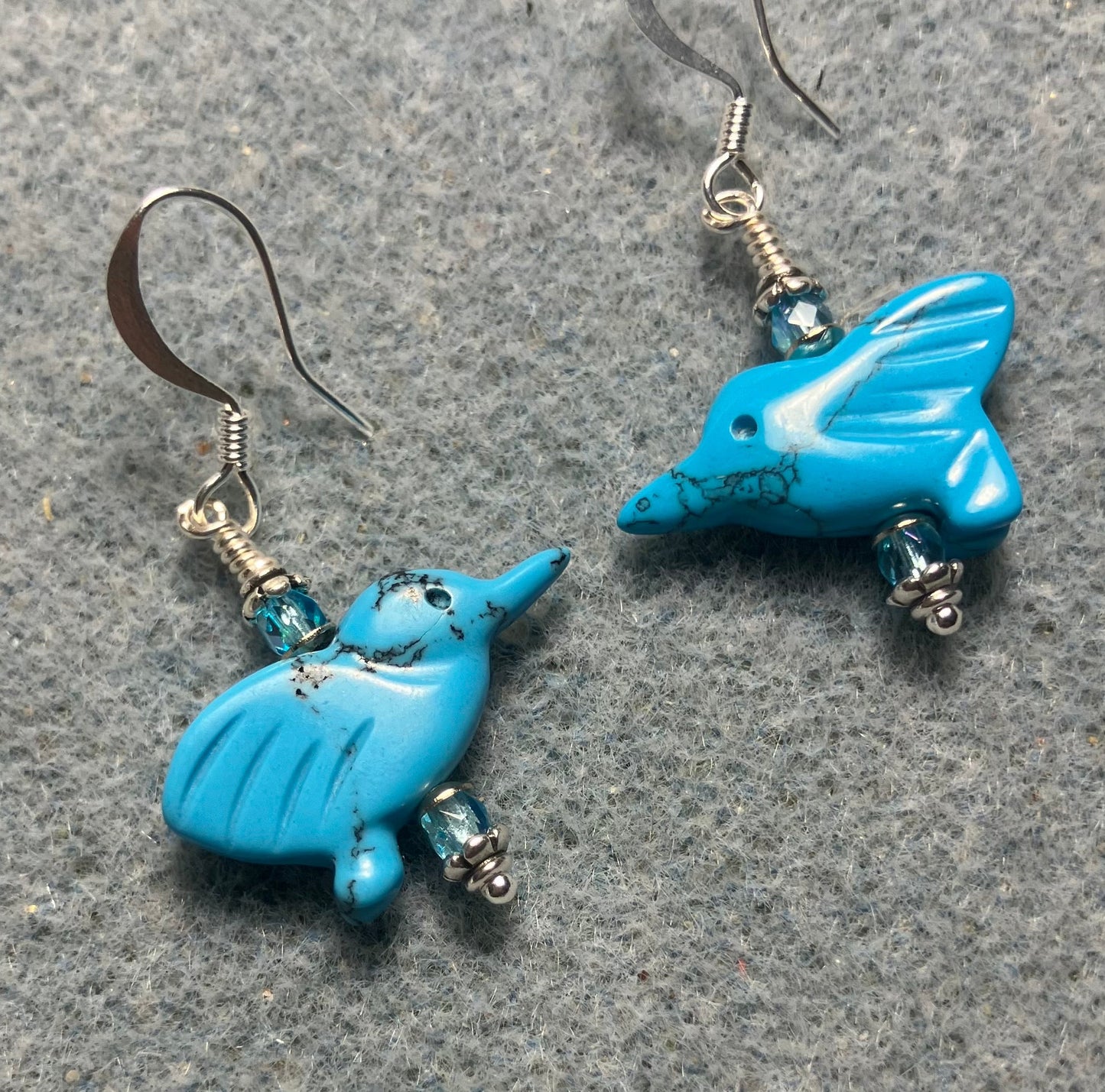 Small turquoise howlite gemstone hummingbird bead earrings adorned with small turquoise Czech glass beads.